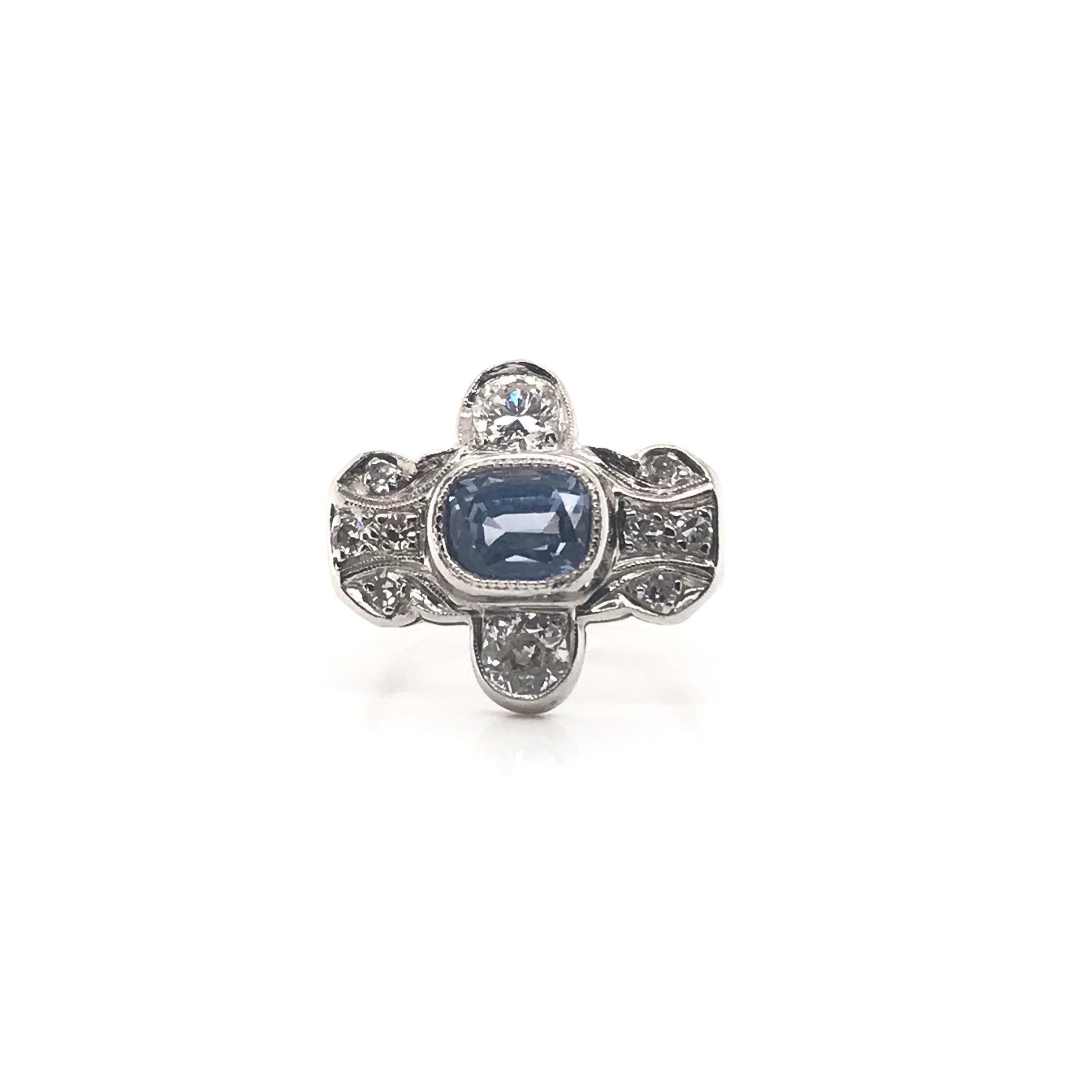 This unique antique piece was handcrafted sometime during the Art Deco design period ( 1920-1940 ). The center stone is a 1.95 carat Ceylon sapphire. Ceylon sapphires are exclusively sourced from the former Ceylon area, now Sri Lanka. Ceylon