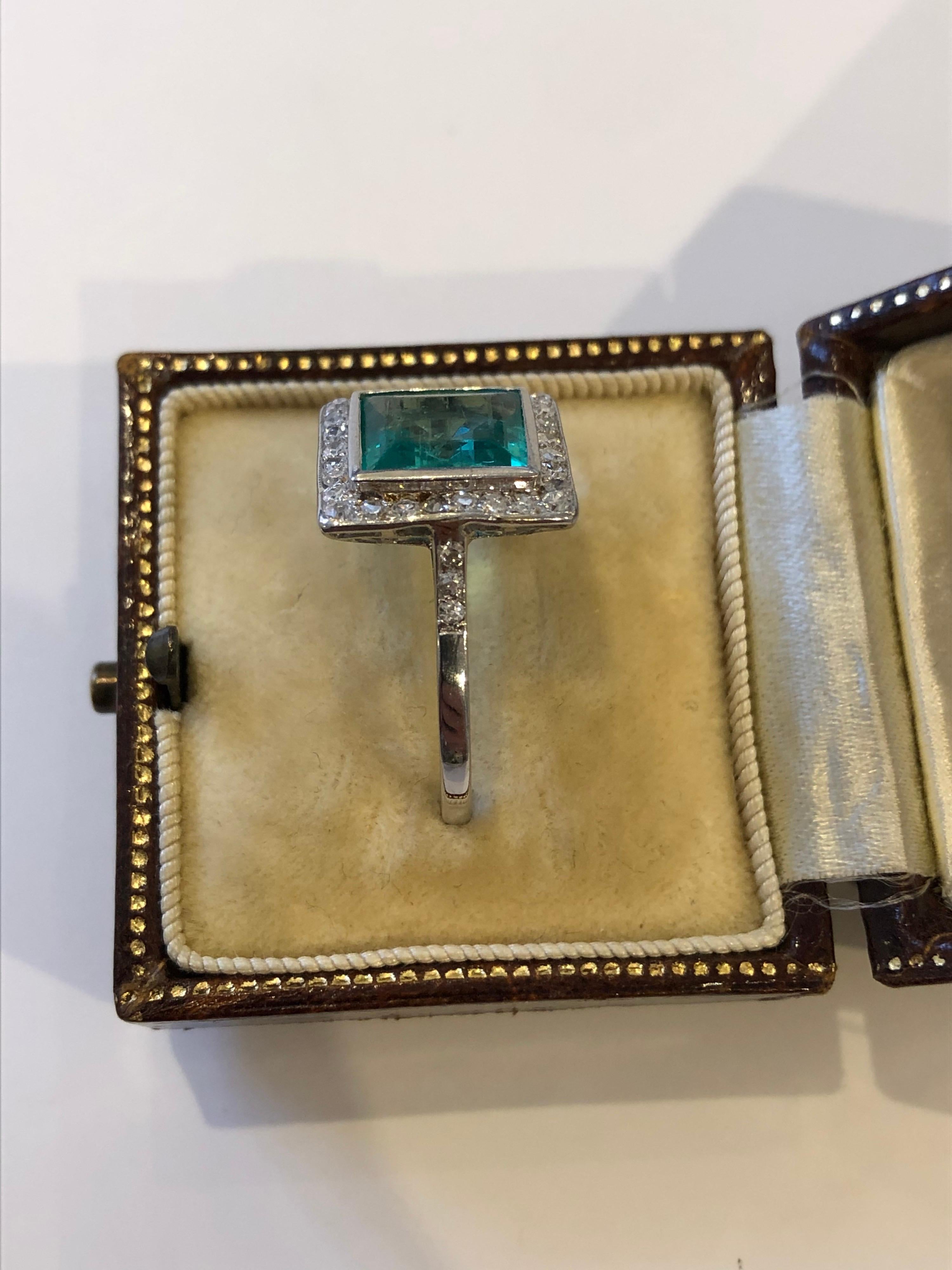 An Art Deco Columbian Emerald and diamond ring. The ring centres a certificated rectangular cut Columbian emerald of 2 carat that has no colour enhancement other than minor oil. 
The ring is accompanied by a certificate from GCS laboratory in