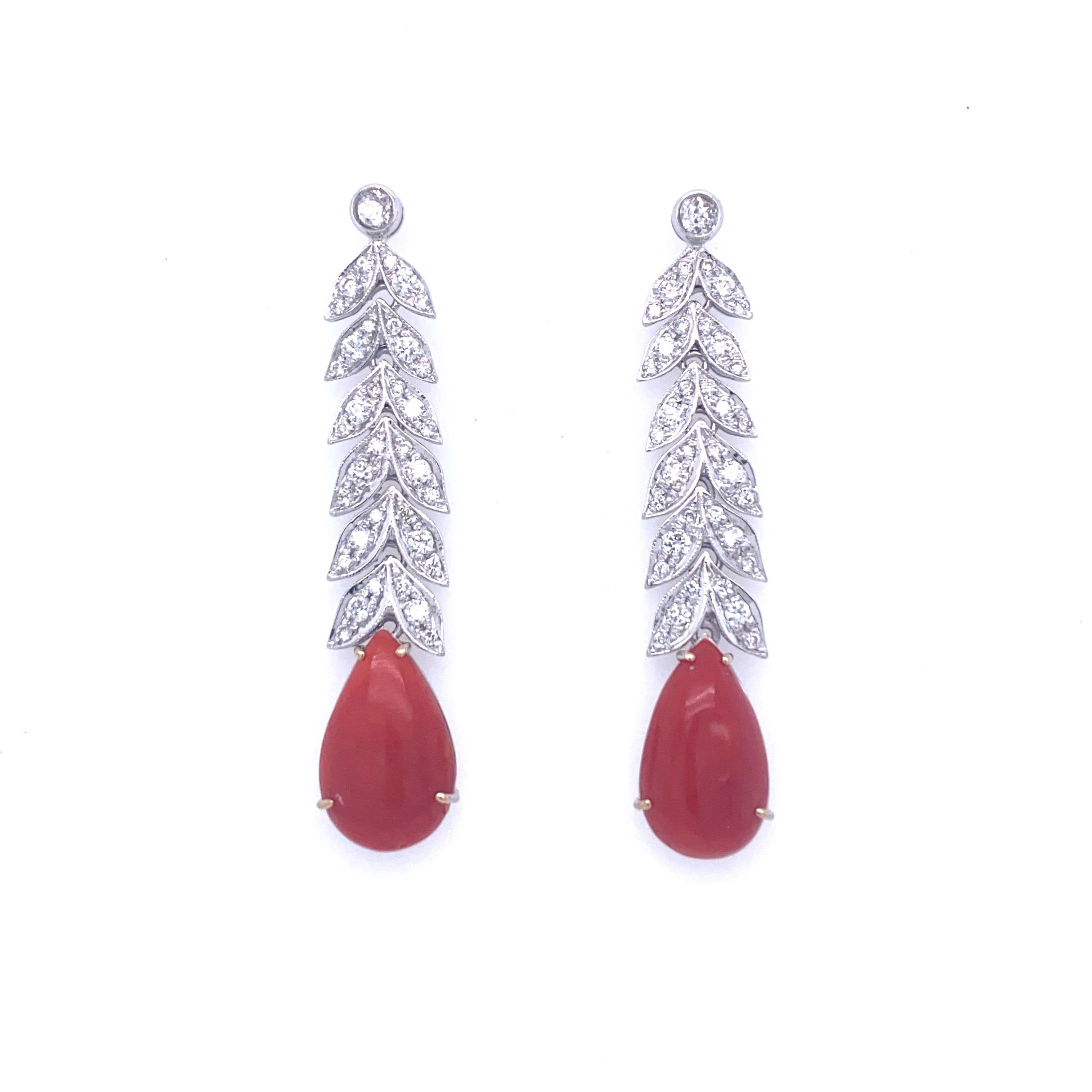These Beautiful Art Deco 18k white gold earrings feature at the bottom 2 large drop natural Aka Coral, connected by leafs design links set with colorless round Diamonds graded G Color Vvs Clarity and weighing approximately 2.00 carat.
Circa
