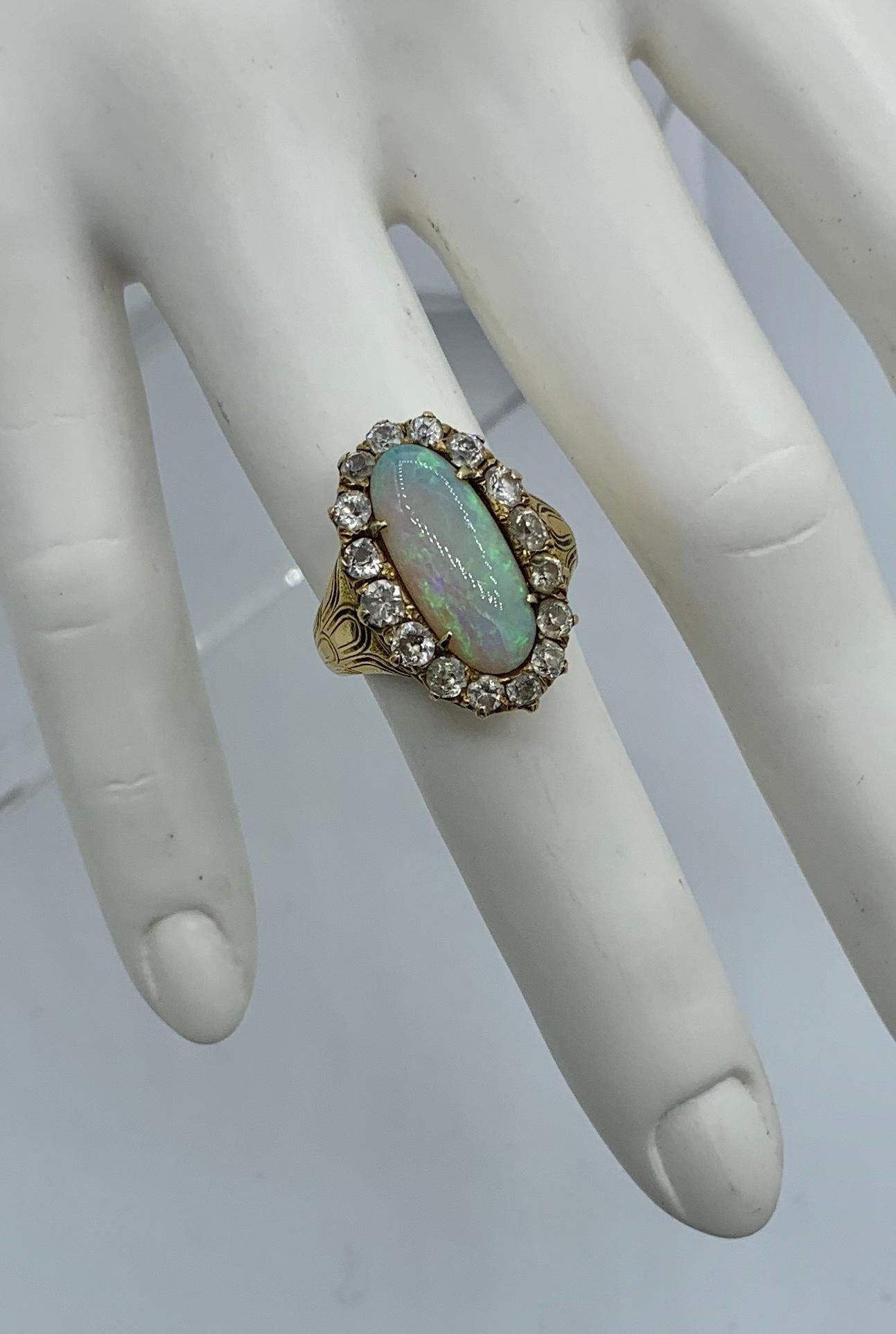 This is one of the most beautiful Antique Belle Epoque - Art Deco Opal Diamond Rings we have seen.  The extraordinary opal has blue, green, yellow and orange fire.  The opal is an oval cabochon of approximately two carats.  The exquisite opal is