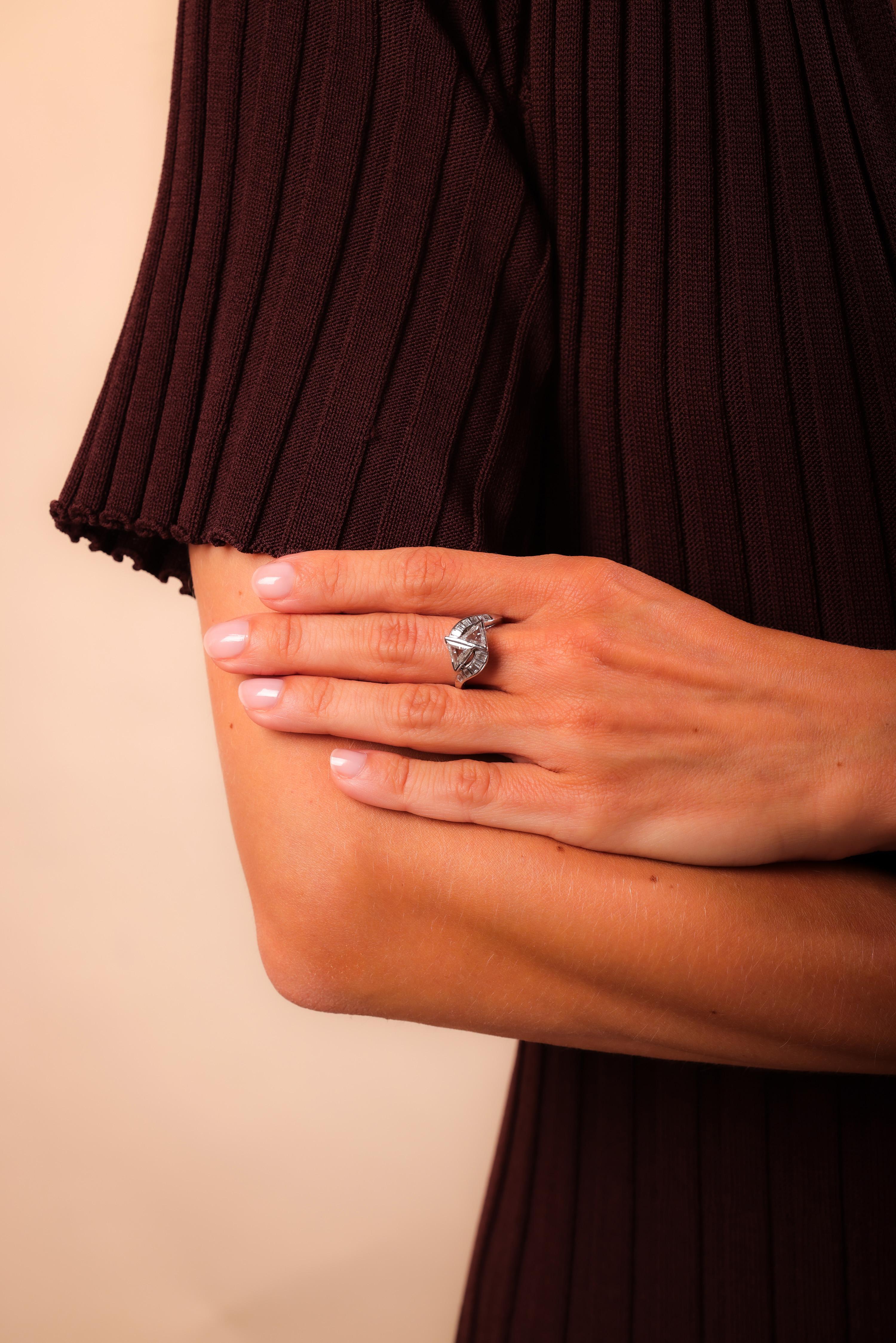 Total Diamond Weight: 2 Carats
Center Stone: 2 Triangle Cut Diamonds
Weight: 1.5 Carat
Color: G
Clarity: VS
Accent Stone: 12 Baguette Cut Diamonds
Weight: .50 Carat
Color: G
Clarity: VS
Metal: Platinum
Era: Art Deco
Circa: 1930's
Hallmarks: Purity