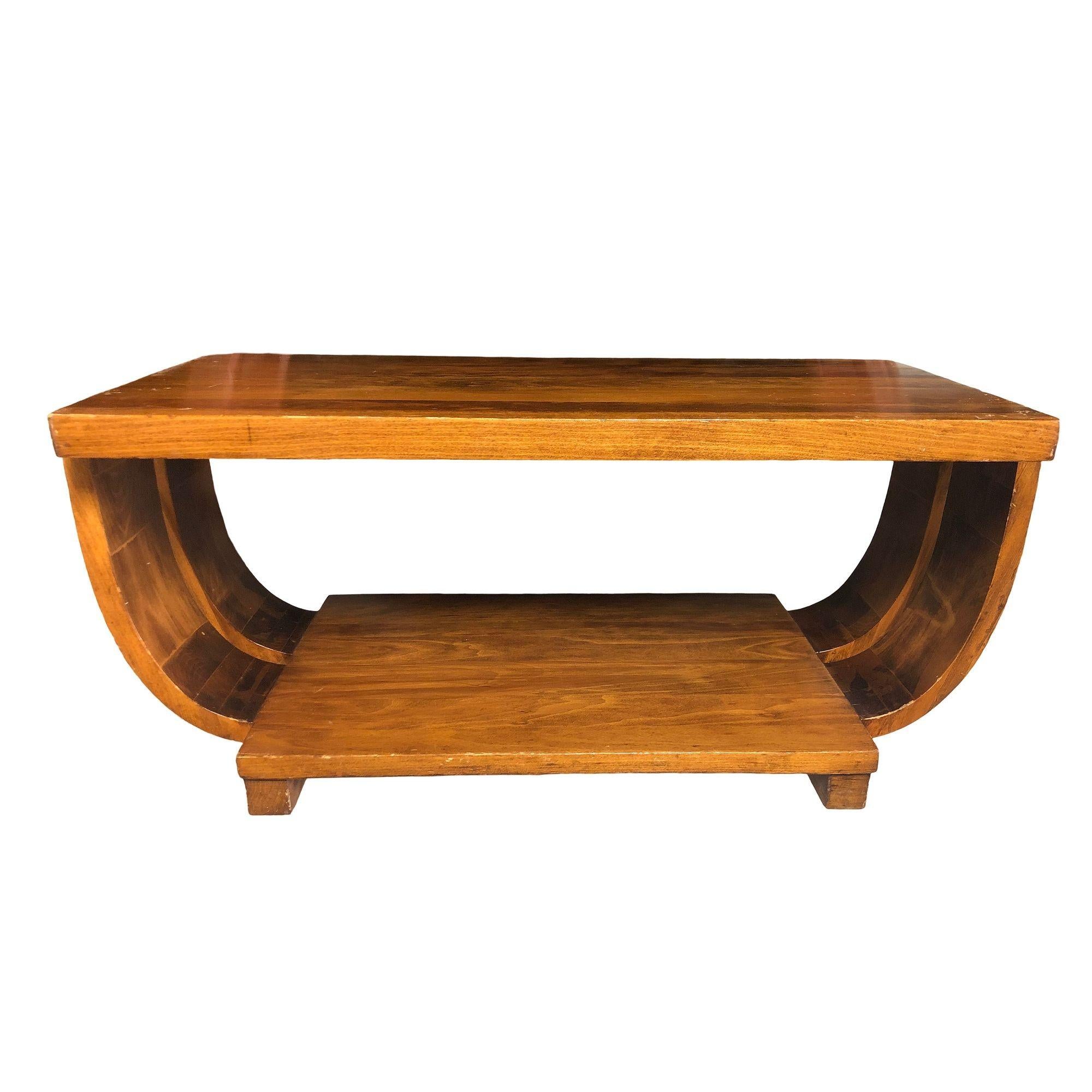 The Art Deco Streamline mahogany coffee/cocktail table by Gilbert Rohde for Brown Saltman. The table showcases a striking round half-moon silhouette on a square geometric base bringing together elegant Modern curves and an exquisite form. The table