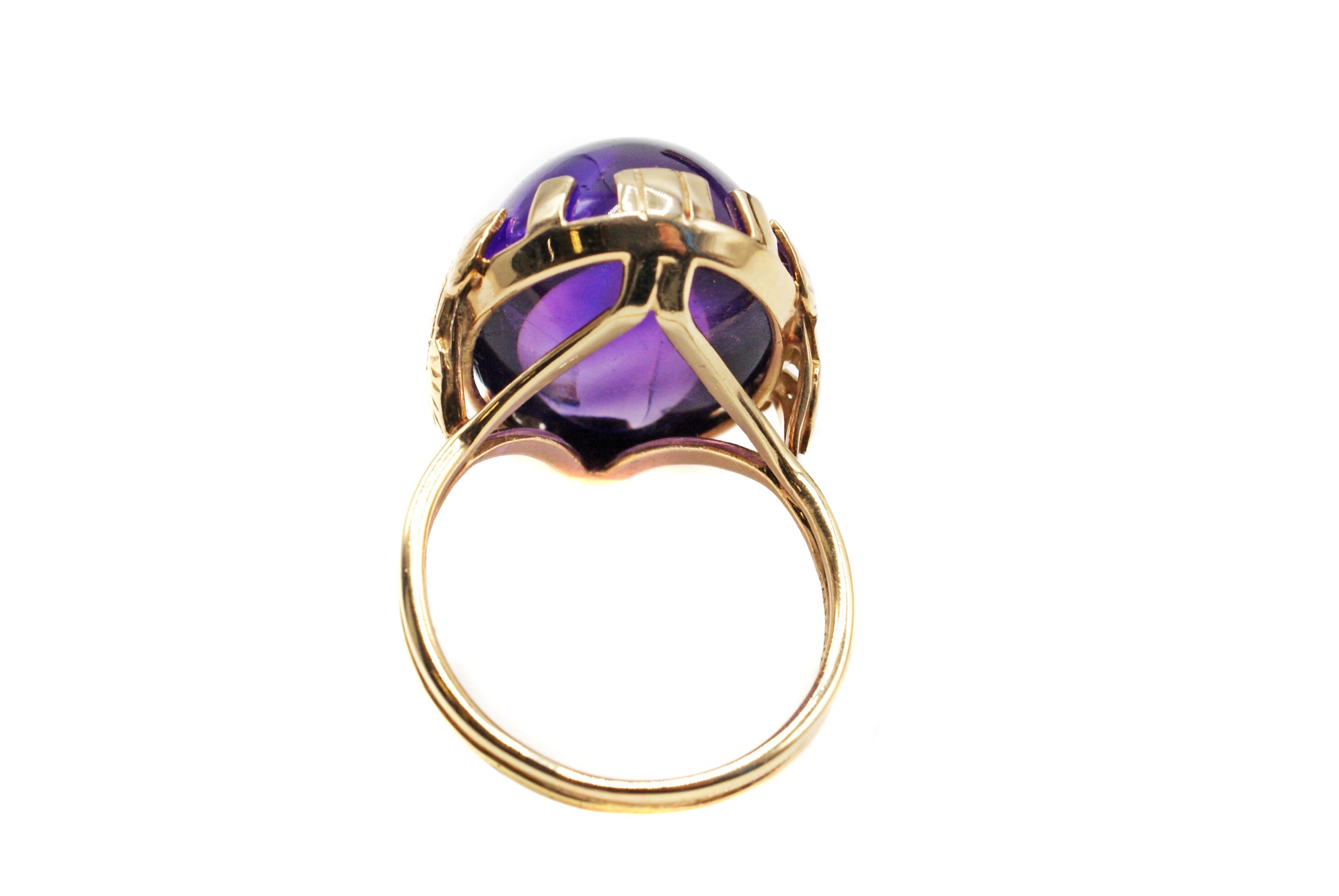 This wonderful Art Deco ring from circa 1935 features a beautifully cut and well proportioned Amethyst cabochon measured to weigh approximately 20 carats. This oval gemstone displays a wonderful deep velvety purple and the perfect polish makes for