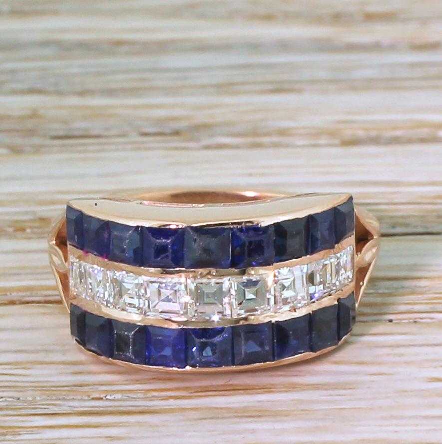 Frankly, you can't get better than this unbelievable vintage sapphire and diamond ring. An unbroken line of nine blindingly white carré cut diamonds are channel set in rose gold, and are sandwiched between two lines of nine rich and bright blue
