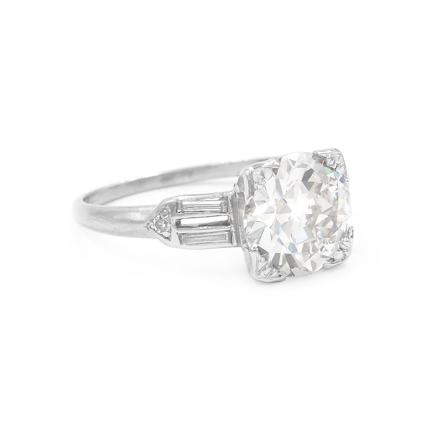 Art Deco era 2.00 Carat Transitional Cut Diamond Engagement Ring composed of platinum. Featuring a 2.00 carat Transitional Cut diamond (an early Round Brilliant Cut), GIA certified L color & VS2 clarity. Set with an additional 4 Straight Baguette