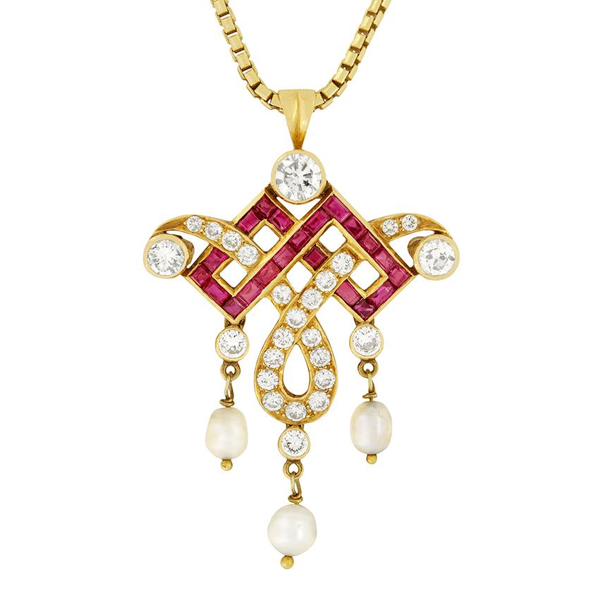 This stunning piece of art deco jewellery captures the style and grandeur of the era. Geometric rubies are interwoven with the graceful swirl of diamonds. A 0.40 carat transitional cut diamond shines at the top of the design, while two 0.25 carat