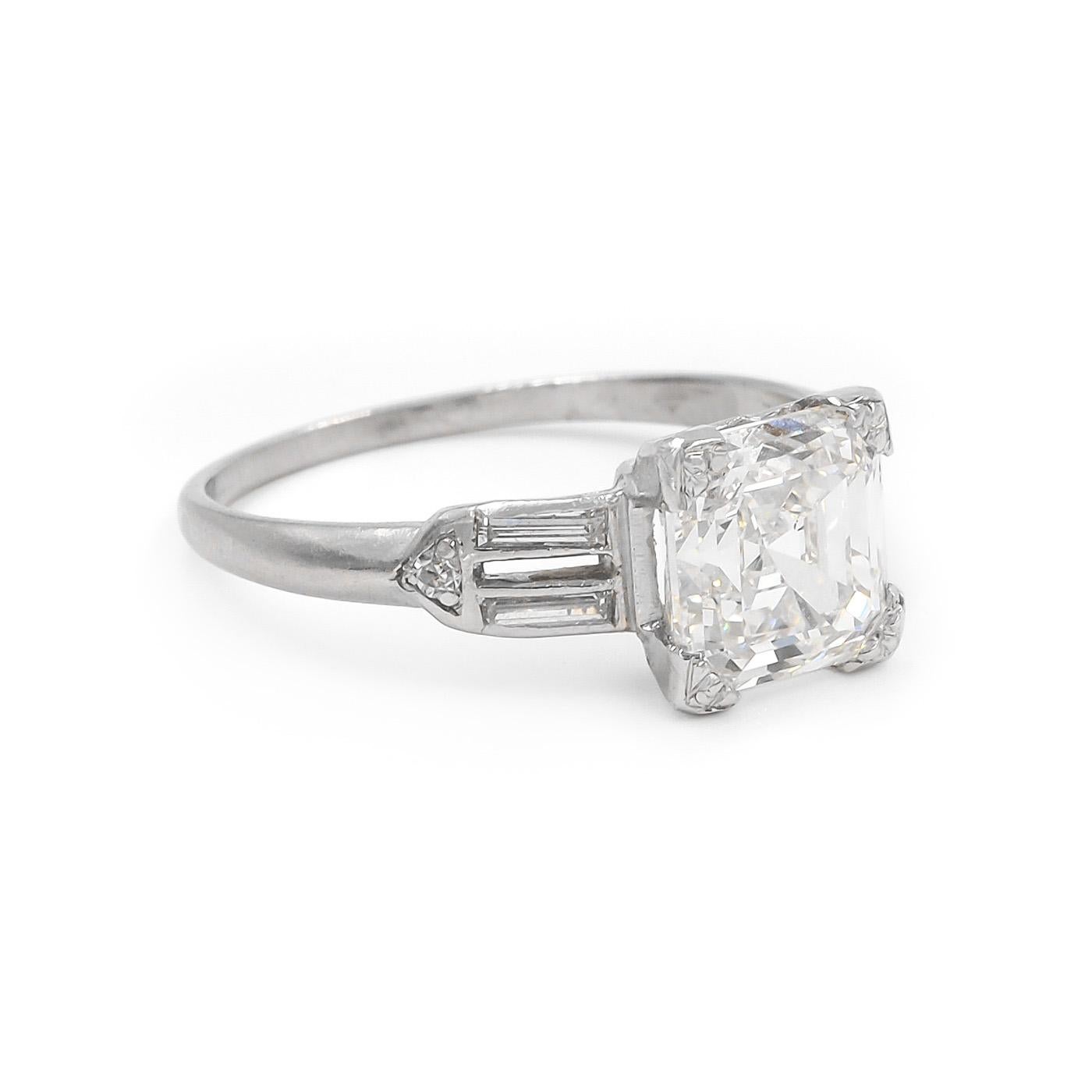 Original Art Deco era 2.01 Carat Asscher Cut Diamond Engagement Ring composed of platinum. Featuring a 2.01 carat Asscher Cut diamond, GIA certified G in color & SI1 clarity. Set with an additional 4 Straight Baguette Cut diamond on the shoulders,