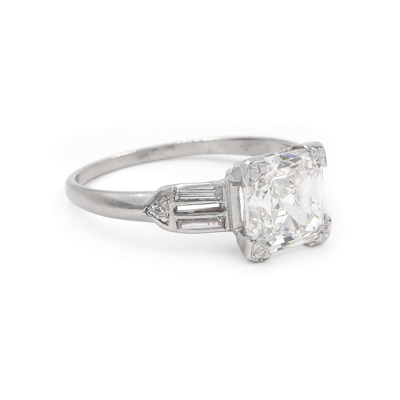 Art Deco era 2.01 Carat Asscher Cut Diamond Engagement Ring composed of platinum. Featuring a 2.01 carat Asscher Cut diamond, GIA certified G color & SI1 clarity. Set with an additional 4 Baguette Cut diamond on the shoulders, weighing approximately