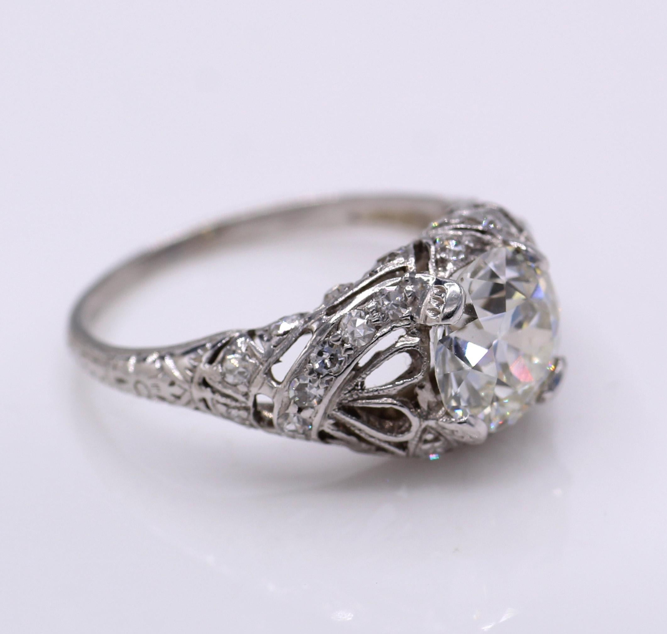Beautifully designed and masterfully handcrafted this Art Deco platinum engagement ring features an Old European Cut diamond weighing 2.03 carats. The unique wider faceting, exclusive to this period bring about an amazing fire and life in this