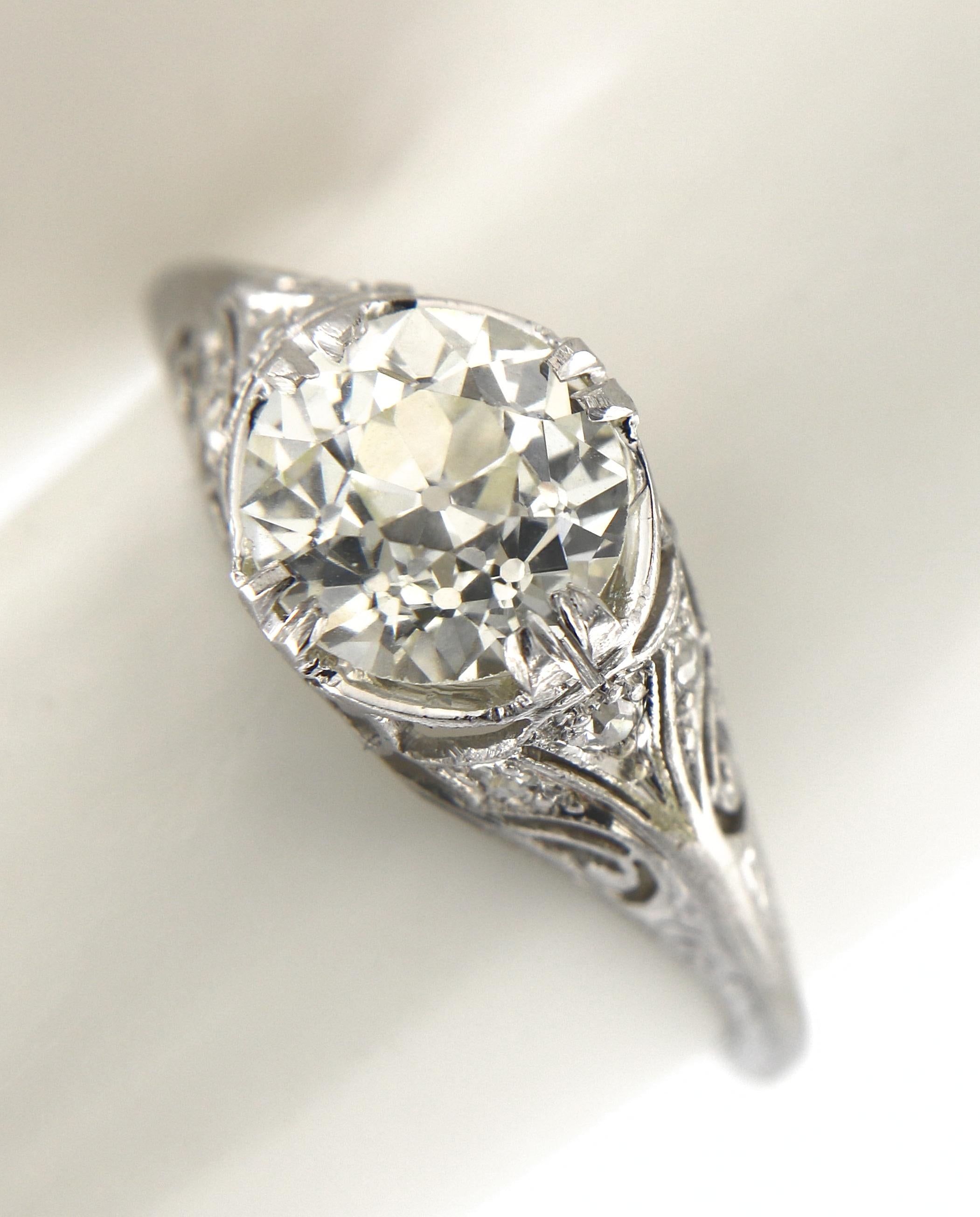 Offered here is an authentic Art Deco diamond engagement ring,
This delicate ring was handmade in platinum, the intriguing filigree design showcases one natural earth mined old European brilliant, G.I.A certified that it is a natural old European