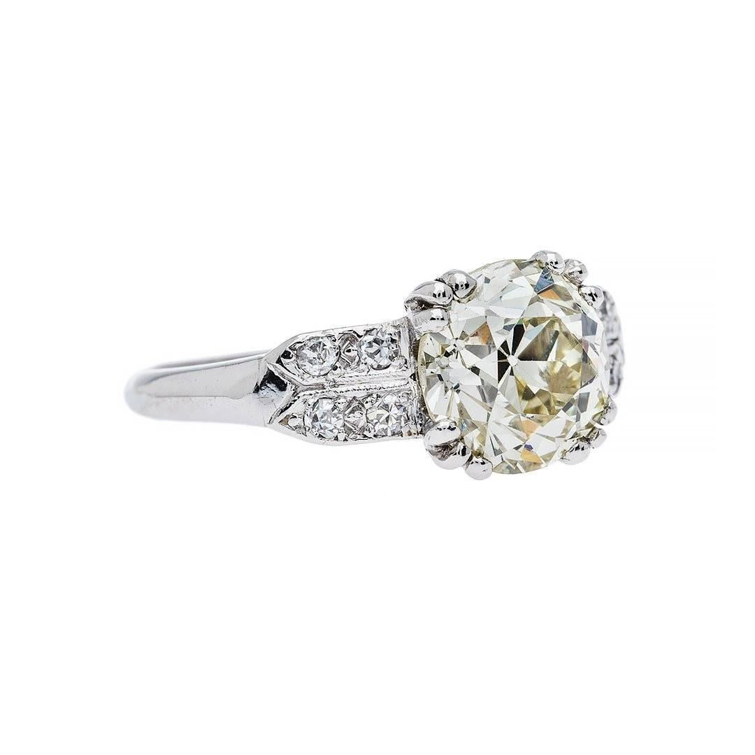 A love to last a lifetime. Created in the 1930's this ring will never go out of style. Featuring a 2.07 carat old European cut diamond that is M color, VS1 clarity accented by shoulders of numerous near colorless diamonds. Hand crafted in platinum. 