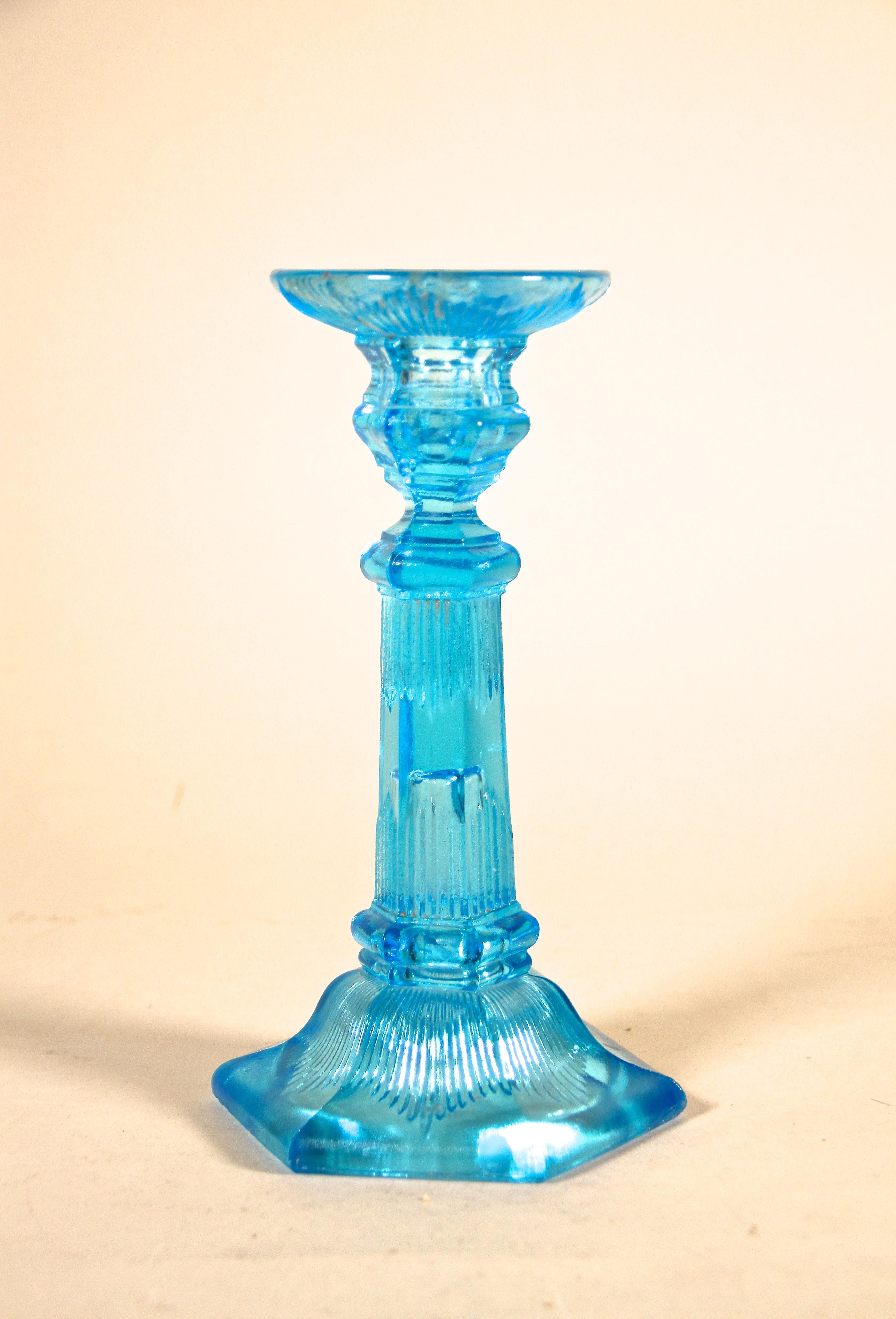 Decorative blue glass candlestick from the Art Deco period in Austria around 1920. Beautifully made of pressed blue colored glass, this candlestick shows a great design. A lovely decoration piece for a table or a sideboard from the early 20th