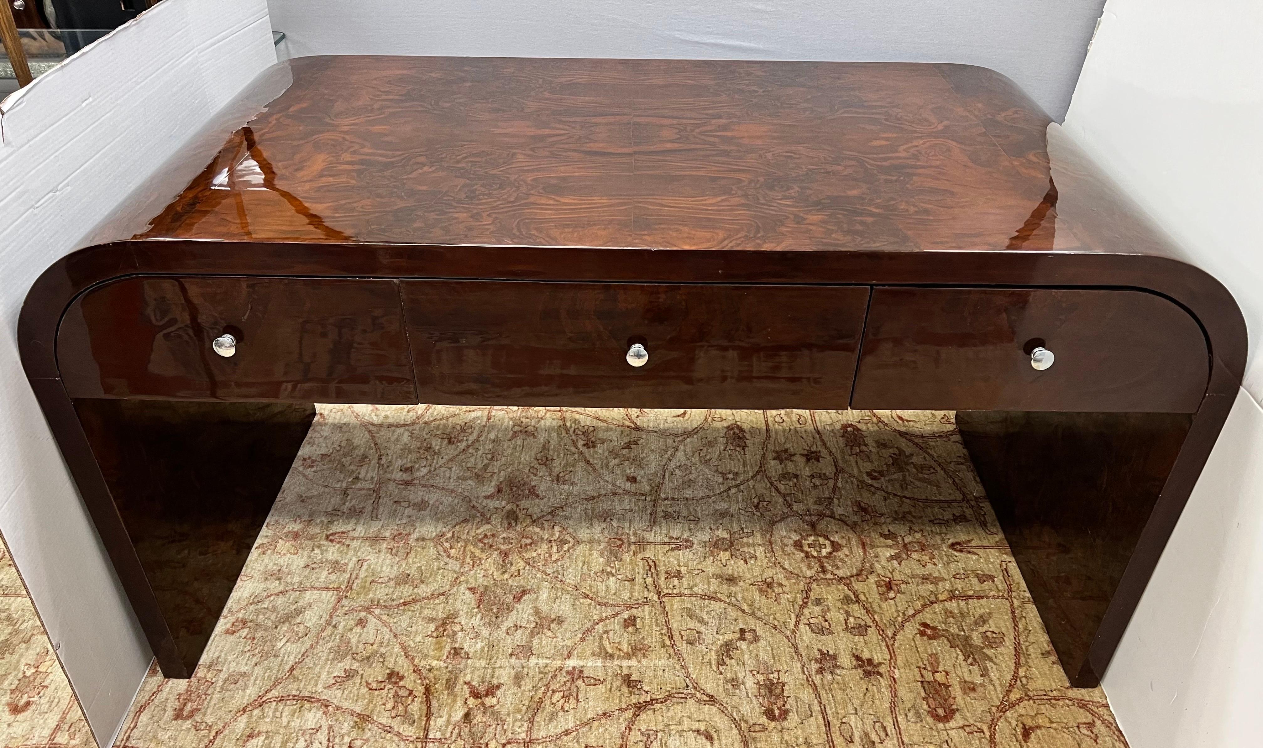Sleek and sexy curved 20th Century Art Deco desk featuring coveted waterfall U-shape. Features three drawers at front. Great lines and better scale. Art Deco feel with a more modern, streamlined aesthetic.