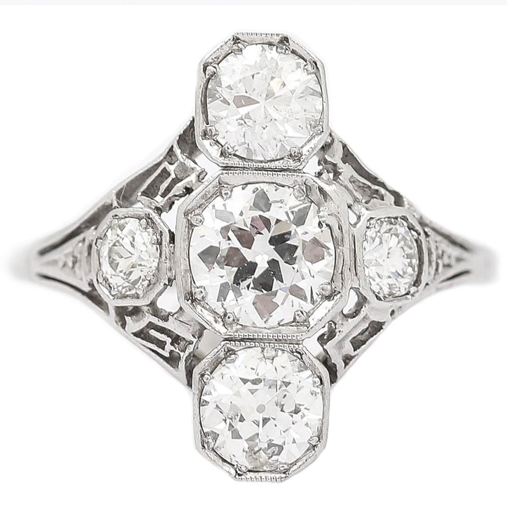 A superb original Art Deco platinum and 18k white gold antique diamond ring.

This is a fine example of design from the glamorous 1920s/30s era. This stunning vintage diamond ring comprises an estimated 2.10cts of old European cut diamonds with the