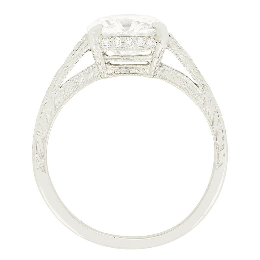This Art Deco take on the timeless solitaire ring is beautifully hand crafted. At it’s centre sits a 2.20 carat old cushion cut diamond with a colour of J and clarity of VS2. The diamond has been delicately claw set into an open platinum collet
