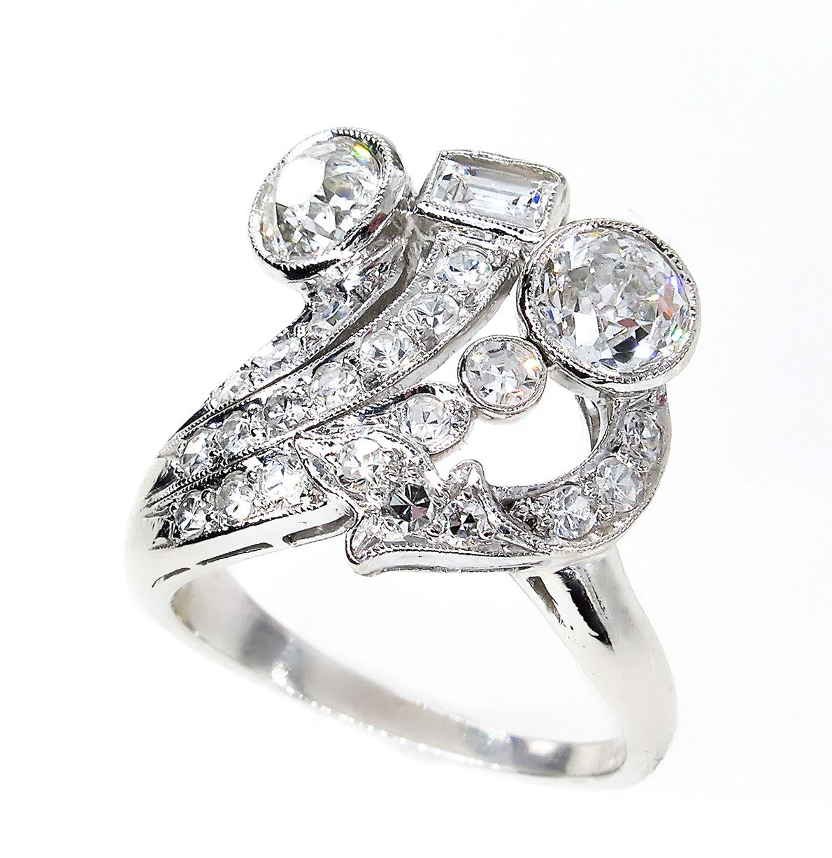 The artfully sculpted, multidimensional mounting combines baguette and Old cut round diamonds for a brilliant , almost a peacock effect.
We estimate the vintage of this ring to be from the 1920s through the 1930s. This is a truly remarkable and