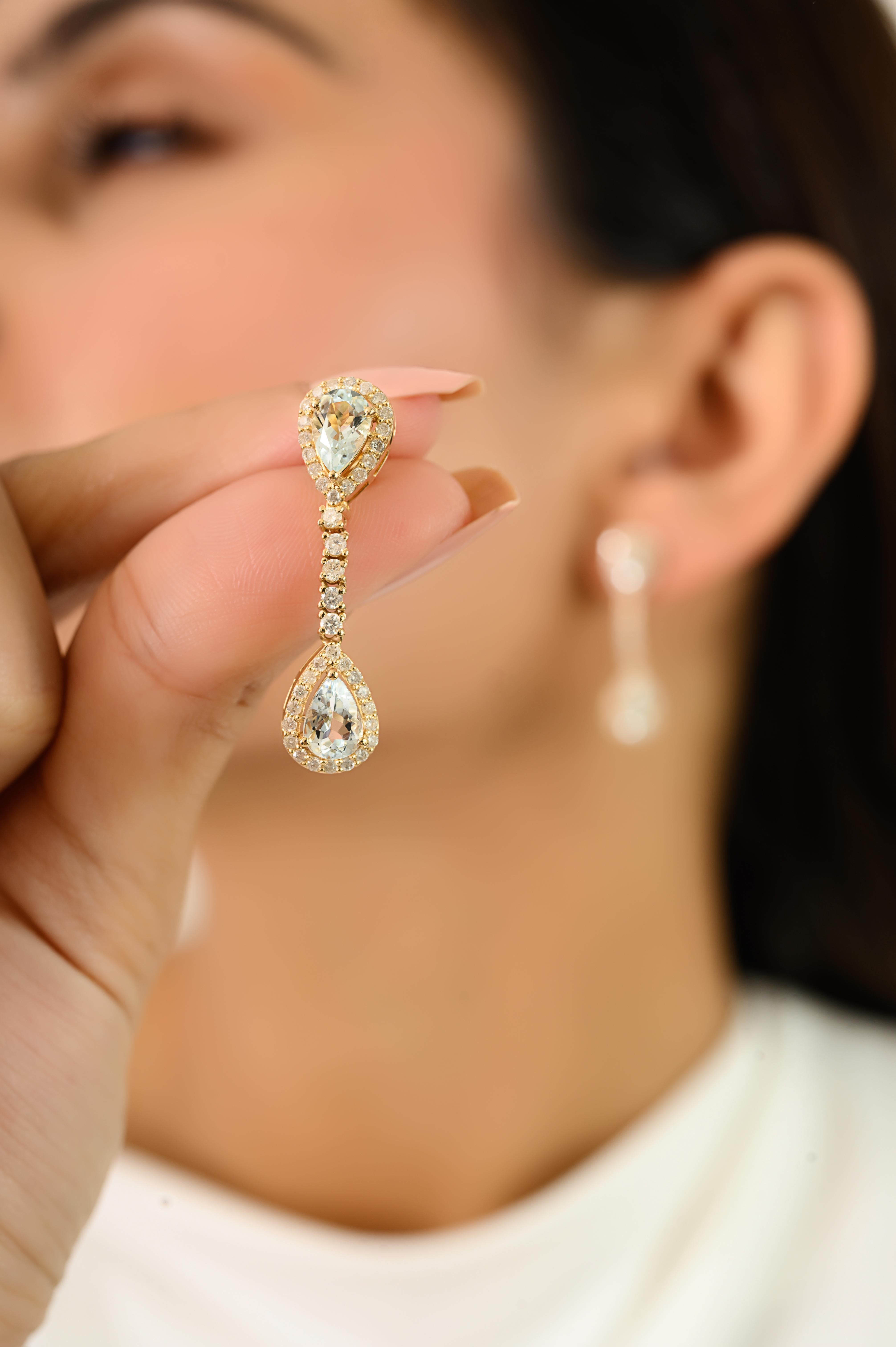 These elegant Art Deco 2.28 Ct Pear Aquamarine & Diamond Dangle Drop Earrings 14k Yellow Gold showcase natural pear cut aquamarines 2.28 carat surrounded by round brilliant diamonds 0.78 carat in a stunning halo prong setting. Expertly crafted in