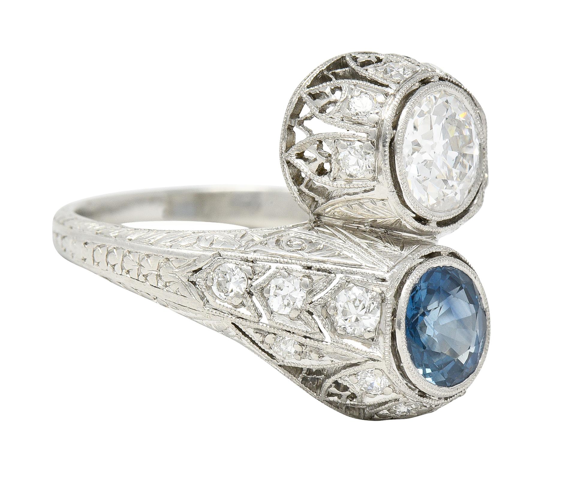 Designed as a bypass style ring terminating with an old European cut diamond and round cut sapphire
Old European cut weighs approximately 0.91 carat - G color with SI1 clarity
Sapphire weighs approximately 0.97 carat - transparent light blue in