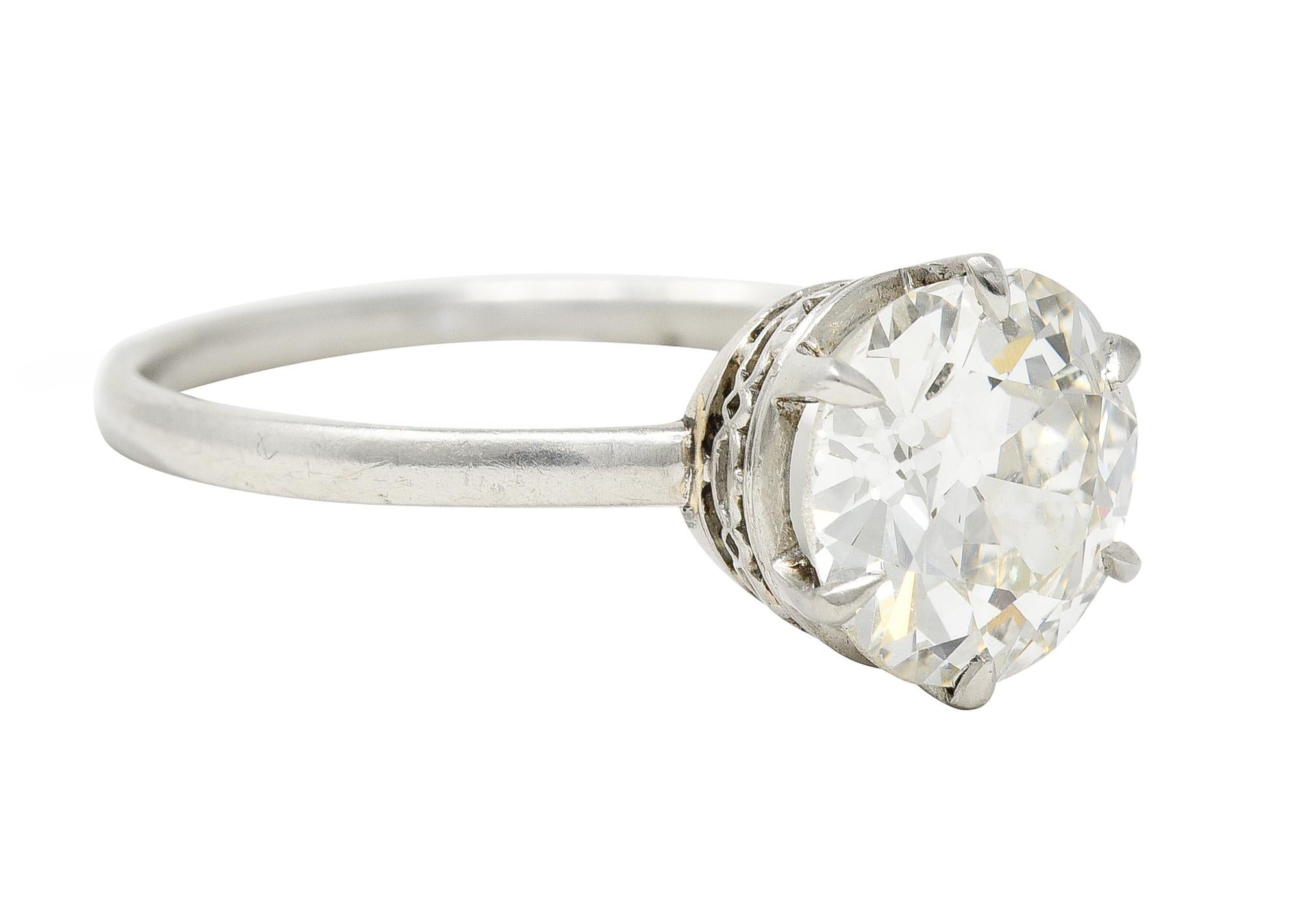 Centering an old European cut diamond weighing 2.29 carats - K color with VS1 clarity. Set in a six prong basket with a pierced gallery. Depicting a geometric pattern fully around. Tested as platinum. Circa: 1930's. Ring size: 6 3/4 and sizable.