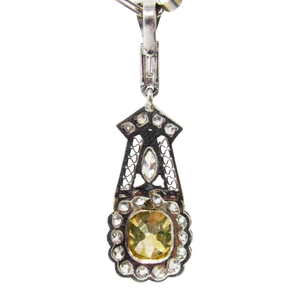 Art Deco Yellow and White Diamond Necklace. Deep yellow cushion shape diamond of natural color is 1.30 carats.  Diamond is SI2 in clarity.  Pendant and chain have a mixture of old european cut diamonds as well as one baguette and one marquise shape