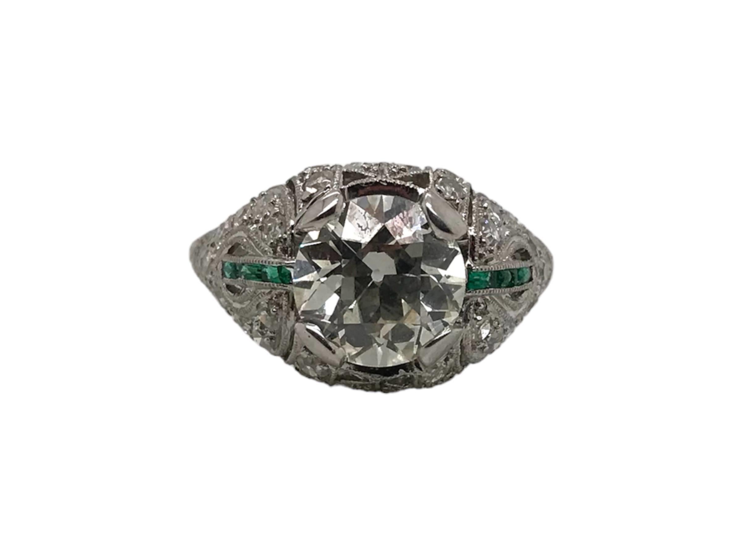 Some vintage pieces just stop your heart. This one definitely made ours skip a beat! 
This lovely Art Deco Era, 1920 - 1940, diamond ring features everything we love from the Era.
The center diamond is a stunning 2.38 Carat Old European Cut Diamond,