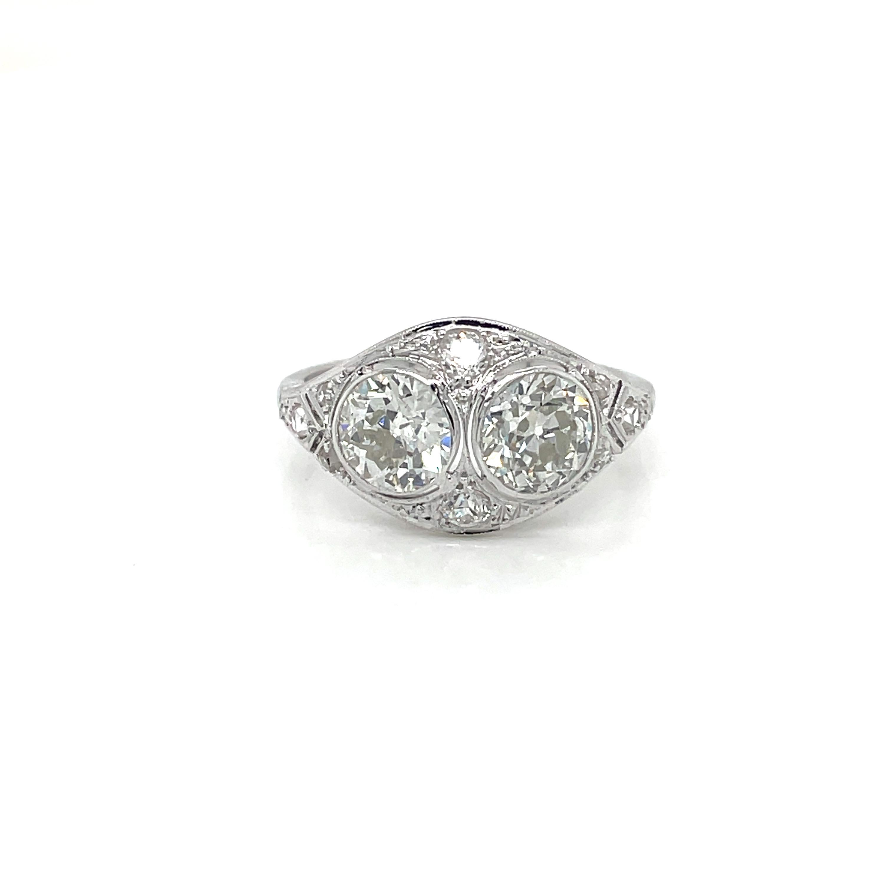 Important genuine Art Deco jewel, this ring is hand-crafted in 18k white gold, authentic from 1920, featuring in the center a perfect couple of sparkling Old mine-cut Diamond weighing 2.30 carats together, graded H color Vs2, surrounded by 0.15
