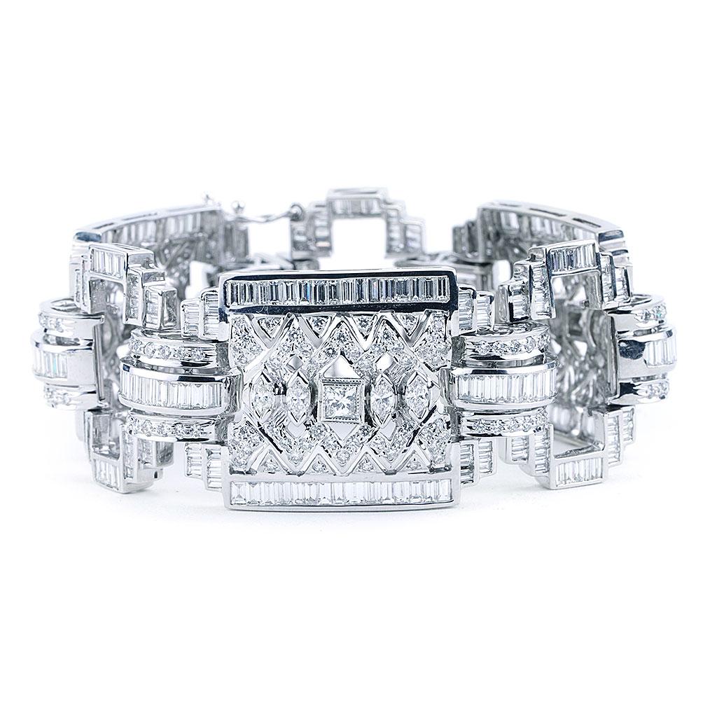 This one-of-a-kind Art Deco diamond bracelet is made of 18K white gold and weighs 59.80 DWT (approx. 93 grams). It is adorned with 366 baguette diamonds G-H color, VS clarity weighing 15.00 carats, 242 round cut diamonds G-H color, VS2-SI1 clarity