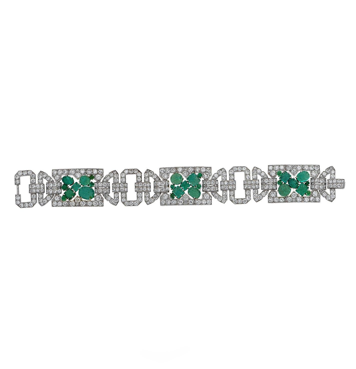 Striking Art Deco Circa 1920s bracelet crafted in platinum showcasing 27 cabochon carved emeralds framed, with 294 European cut diamonds weighing approximately 25 carats total, h color, vs clarity. This stunning piece measures 7.25 inches in length