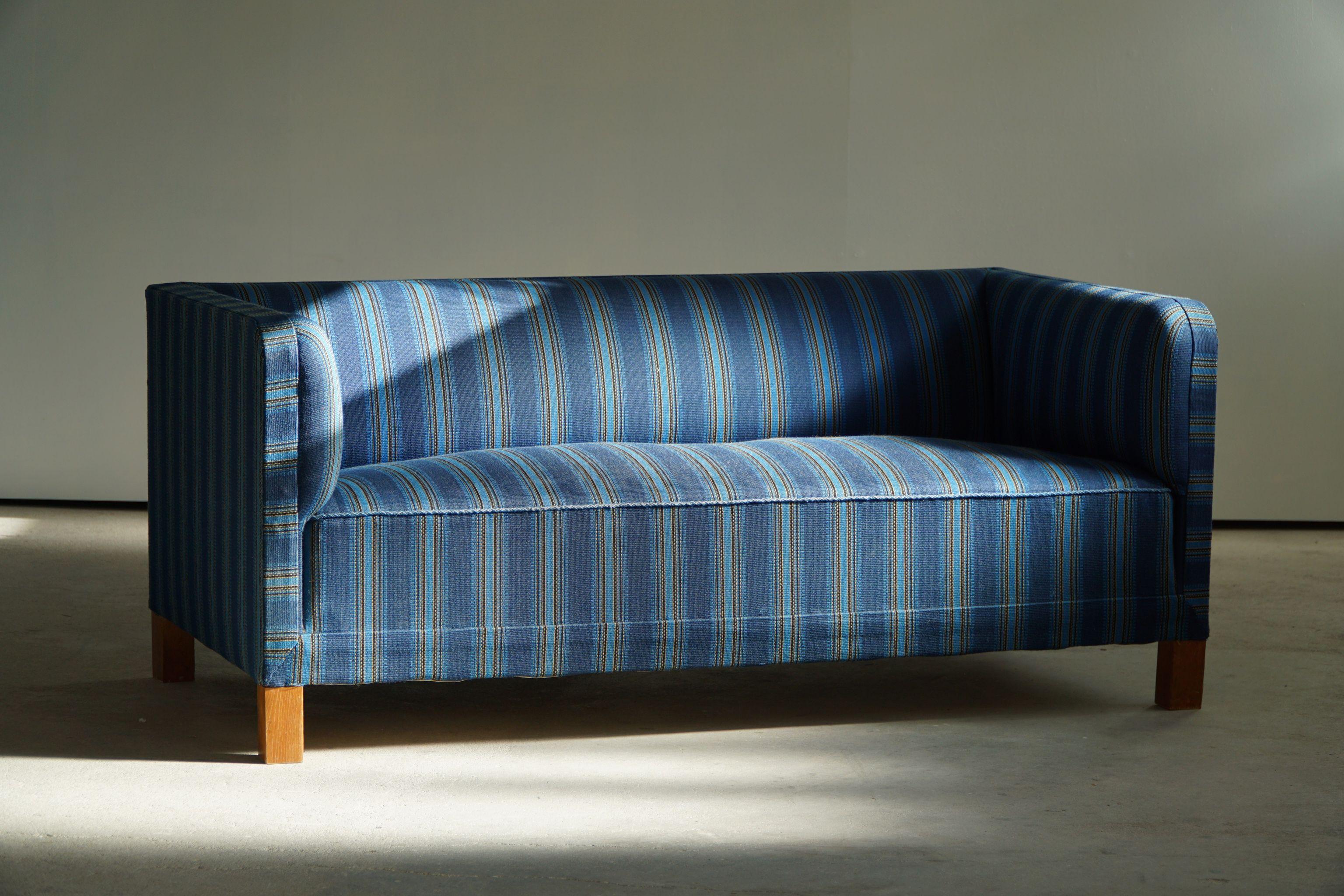A rare and truly amazing 2.5 seater sofa in the style of Flemming Lassen. Made by a Danish Cabinetmaker in 1930s. The overall impression of this sofa is really good, still with the original vintage fabric.

A classic design with great curves that