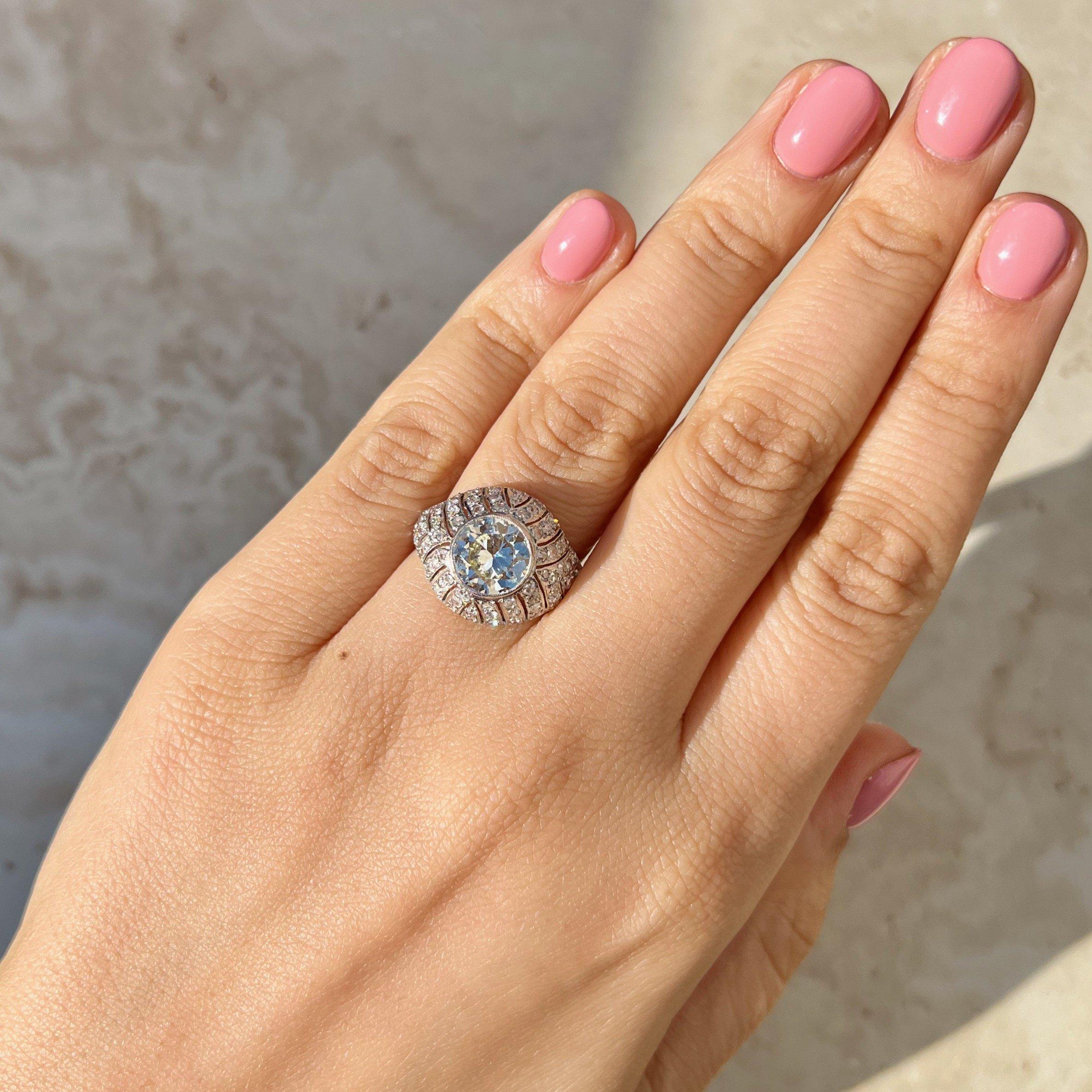 An antique dome ring with a stunningly bright Old European cut center that shines from across the room. There's something so special about a classic old Euro, and this 2.25 carat center diamond give us all that old-world charm. Set in a platinum