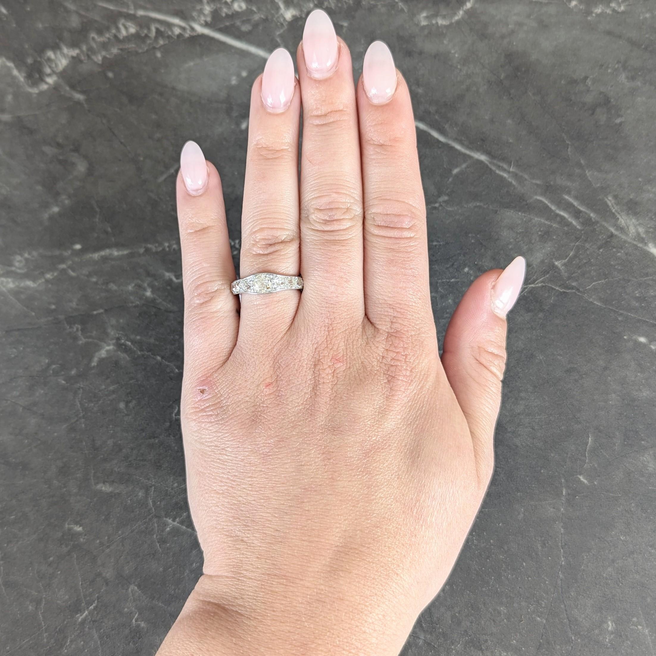 Centering an old mine cut diamond bead set east to west
Weighing approximately 0.58 carat total
K/L color with I2 clarity - one surface reaching inclusion
Flanked by additional diamonds bead set down shank
Weighing approximately 1.92 carats total
L