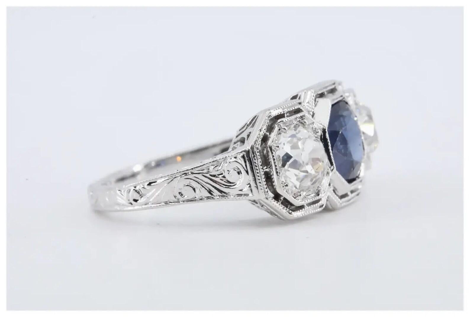 An Art Deco period three stone sapphire, and diamond engagement ring in platinum.

Centered by a beautiful royal blue 1.10 carat No Heat sapphire.

Framed by well a pair of matched old mine cut diamonds of 1.40ctw with G color and SI1