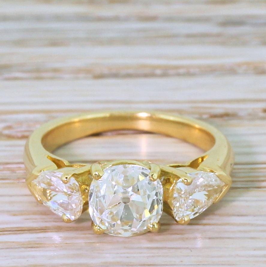 Oh wow! An awesome vintage three stone ring. The cushion shaped old mine cut diamond in the centre – graded by EGL as I colour, VS1 clarity -is secured in a four claw collet designed to let as much light as possible to pass through the stone. A pair