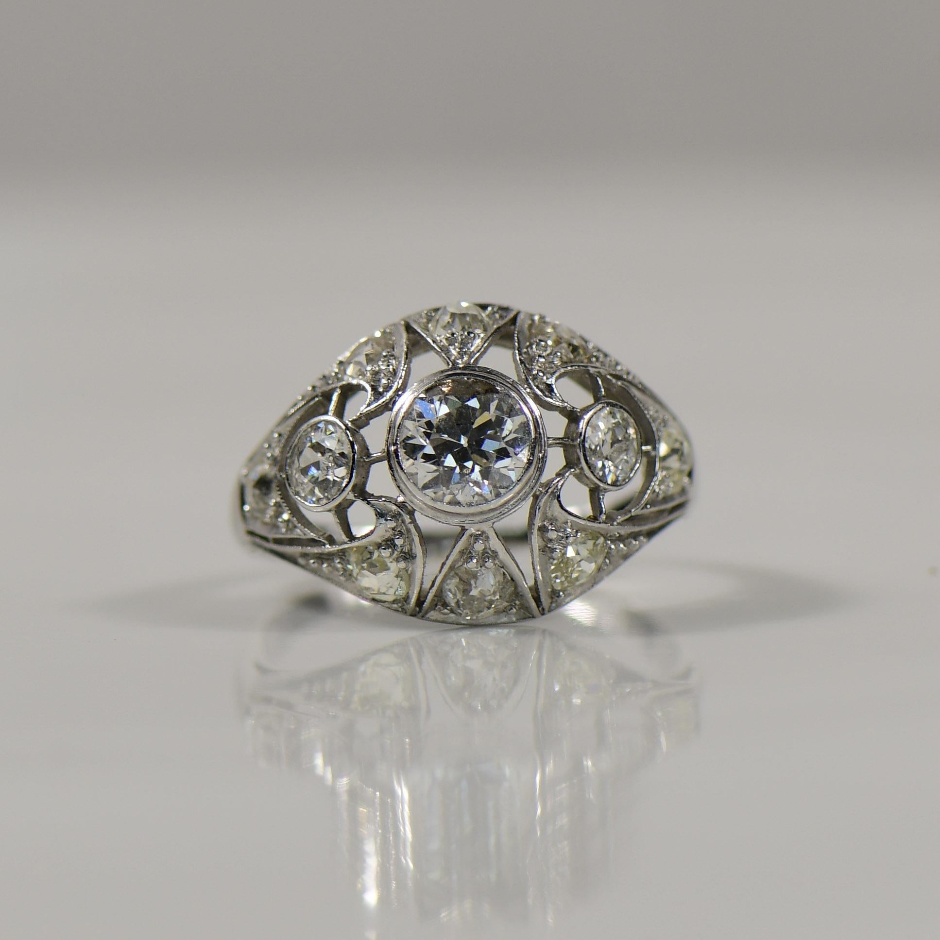 Elegance takes center stage in this Art Deco-inspired platinum cocktail ring, where meticulous craftsmanship meets vintage allure. The geometric openwork design, intricately fashioned in platinum, exudes a timeless sophistication reminiscent of the