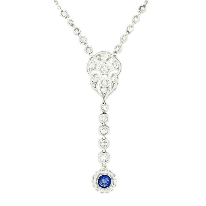 A stunning example of Art Deco craftsmanship, this diamond and sapphire necklace radiates timeless elegance. At the base of the pendant, a 0.50 carat natural unheated sapphire is rub over set and framed by 0.43 carats of sparkling old cut diamonds.
