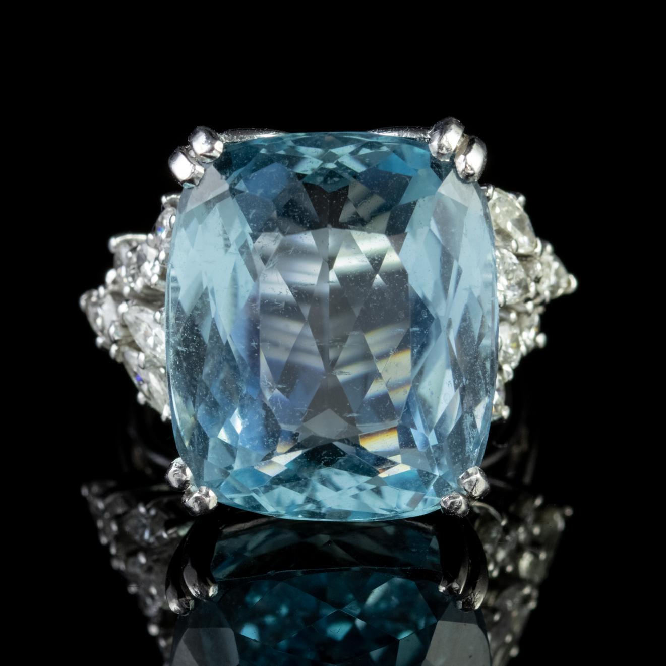 A magnificent Art Deco cocktail ring boasting a spectacular deep blue Aquamarine which is approx. 25ct with decorative shoulders set with old round cut and Marquise cut Diamonds.

Aquamarine is adored for its beautiful clear Ocean blue colour which