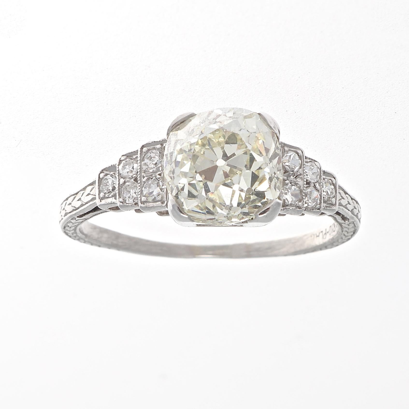 Tradition and design that will last a lifetime. Featuring a warm and charming 2.60 carat old mine cut dimaond that accented by tiered levels of near colorless old cut diamonds. Crafted in platinum. Ring size 8 and can easily be resized to fit, if