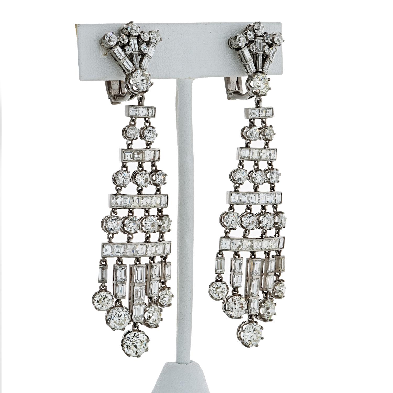 A magnificent pair of 27-carat diamond chandelier earrings. The earrings are comprised of old cut and baguette-shaped diamonds weighing approximately 27.50 carats. The diamonds are G-H color and VS-SI clarity . These dramatic earrings exemplify the