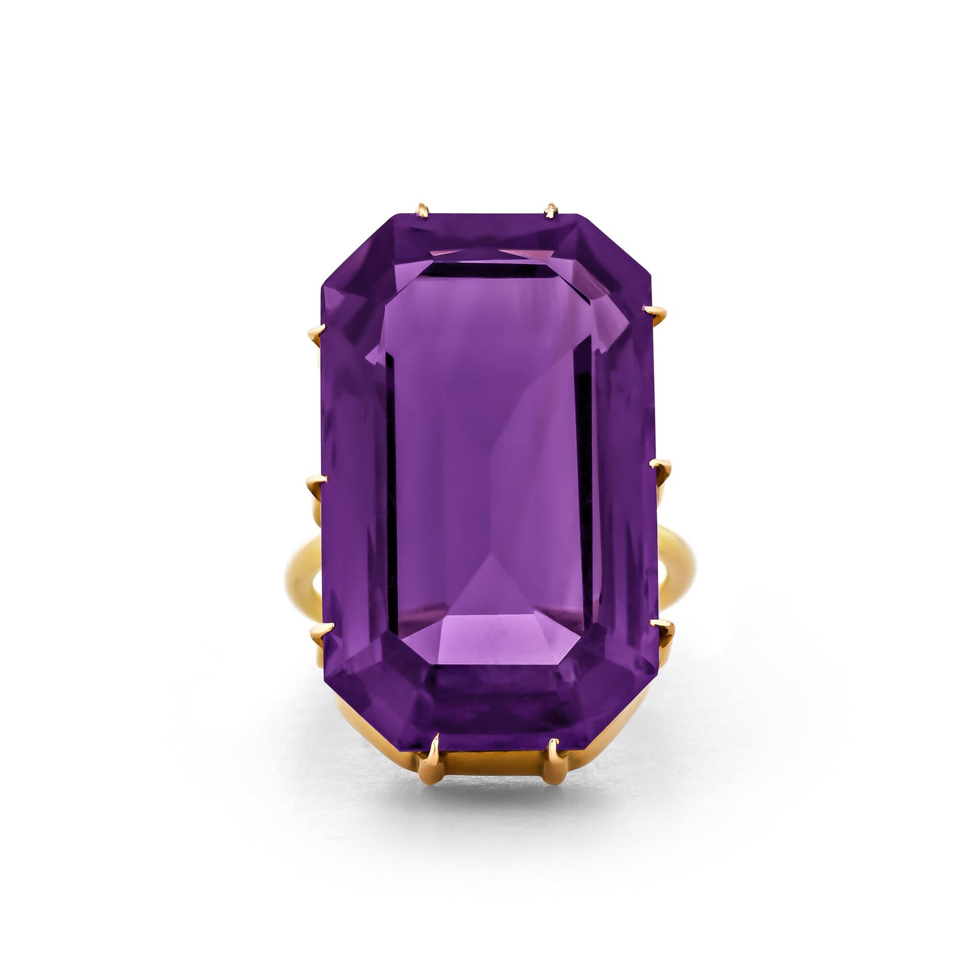 Sumptuously luminous with vivid violet hues, this Art Deco 28.05 carat amethyst ring is high style at its best.  With a handmade 18 karat yellow gold ten prong mounting, this circa 1910 statement ring clearly reflects the elegance of that celebrated