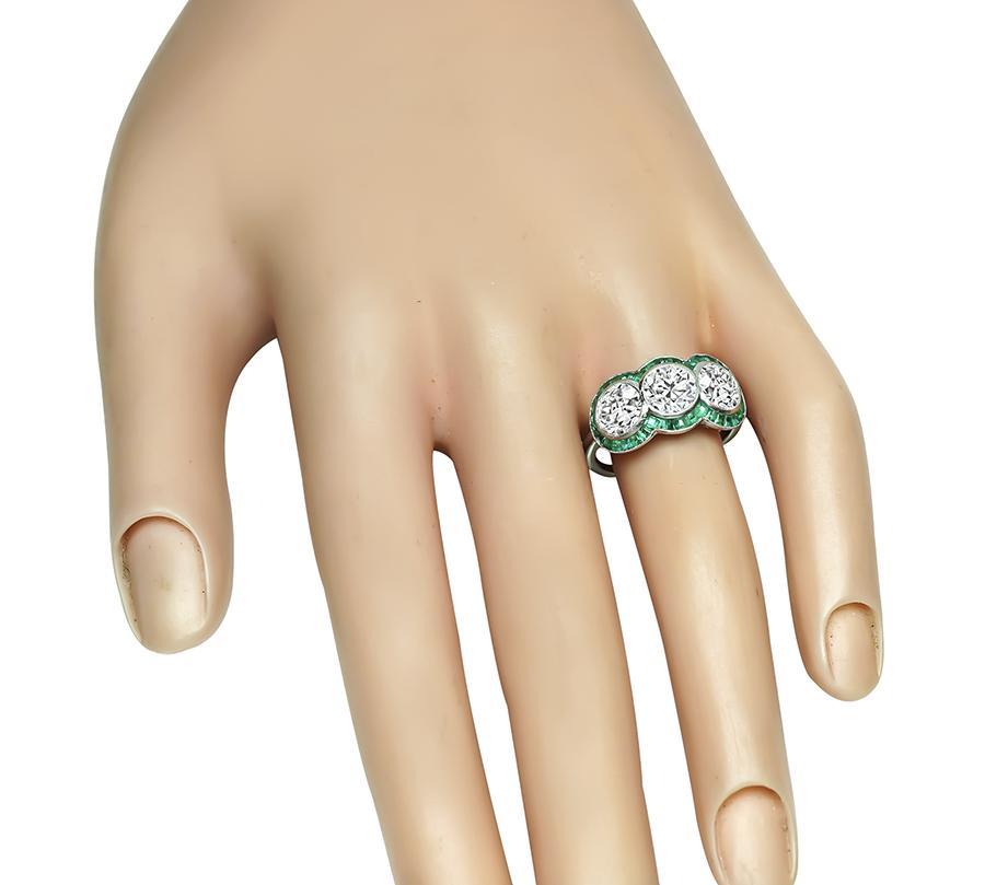 This is a gorgeous platinum anniversary ring from the Art Deco era. The ring is set with three sparkling old European cut diamonds that weigh approximately 2.82ct. The color of the diamonds is G-H with VS clarity. The diamonds are accentuated by