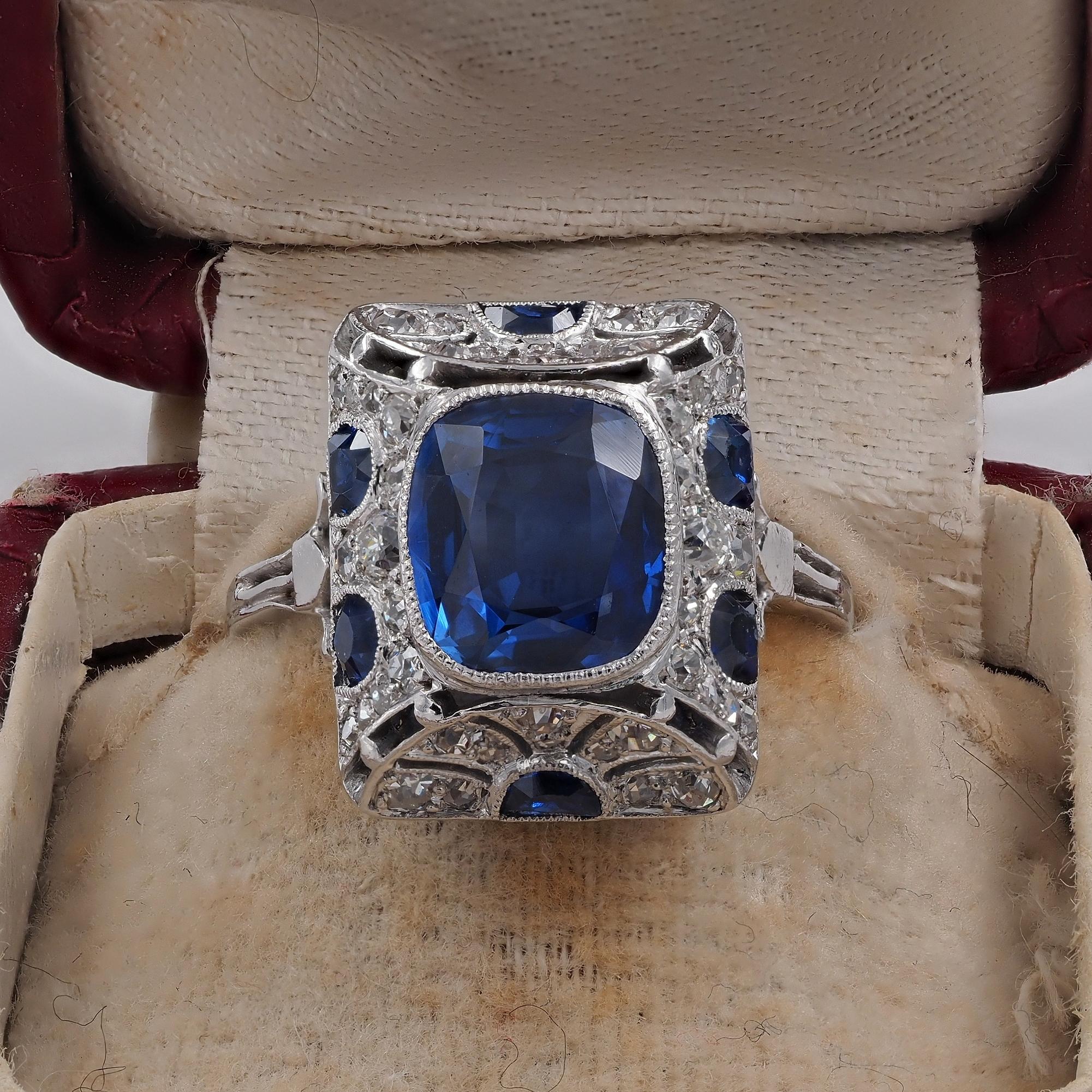 Distinctive Art Deco period Diamond Sapphire ring, 1920 ca. 
Design is a triumph of beauty, skillfully and artfully hand crafted of solid Platinum
French import duty, 1920 ca
Centered by a rare, unheated, natural sapphire Burma origin,  richly