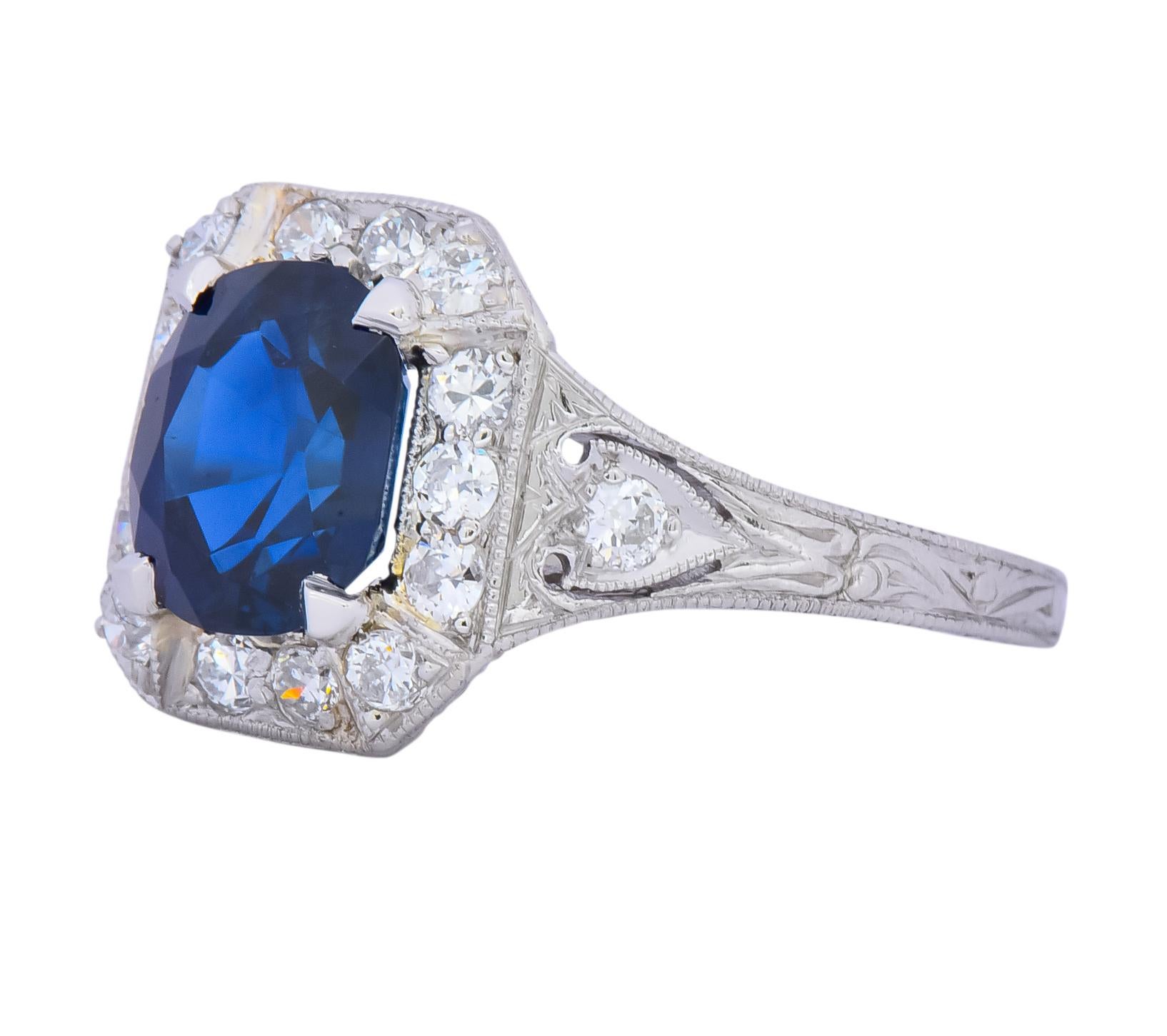 Centering an oval cut sapphire weighing 2.36 carats, deep royal blue with no evidence of heat treatment

Accented by old European cut diamonds, weighing approximately 0.50 carat total, G color and VS to SI clarity

Slightly tiered halo with pierced