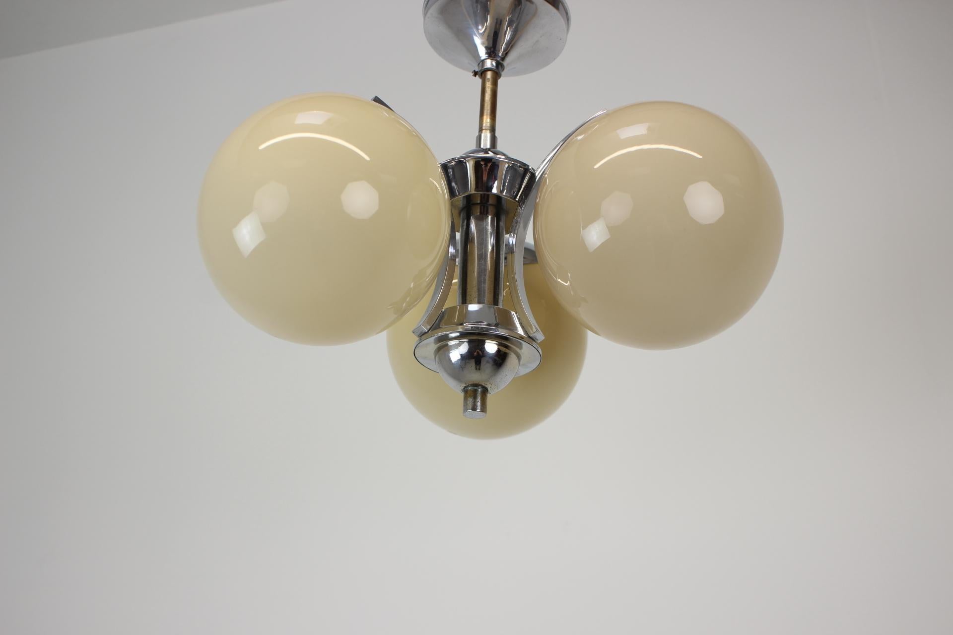 Art Deco 3-flamming chandelier 
Polished, rewired
3x40W, E25-E27 bulbs
US wiring compatible
It is also possible to put a longer central rod.