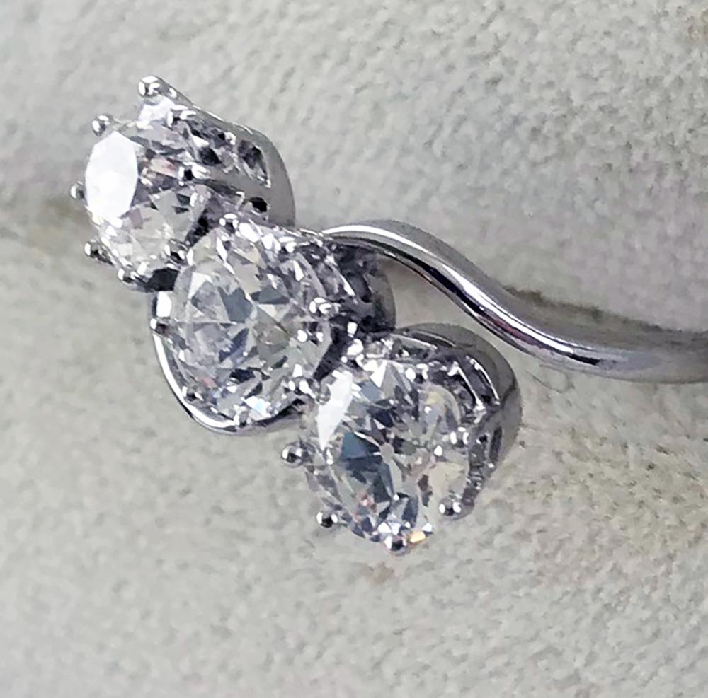 Art Deco 3 Stone Diamond ring set in platinum Ring circa 1920

Three transitional cut diamonds:

0.69 carat, E, SI2
0.53 carat, H, SI2
0.60 carat, F, SI2

Set in a Platinum shank. 

Ring Size:

L 1/4 (UK)
5 3/4 (US)
11 (FR/JP)

Courtesy resizing to