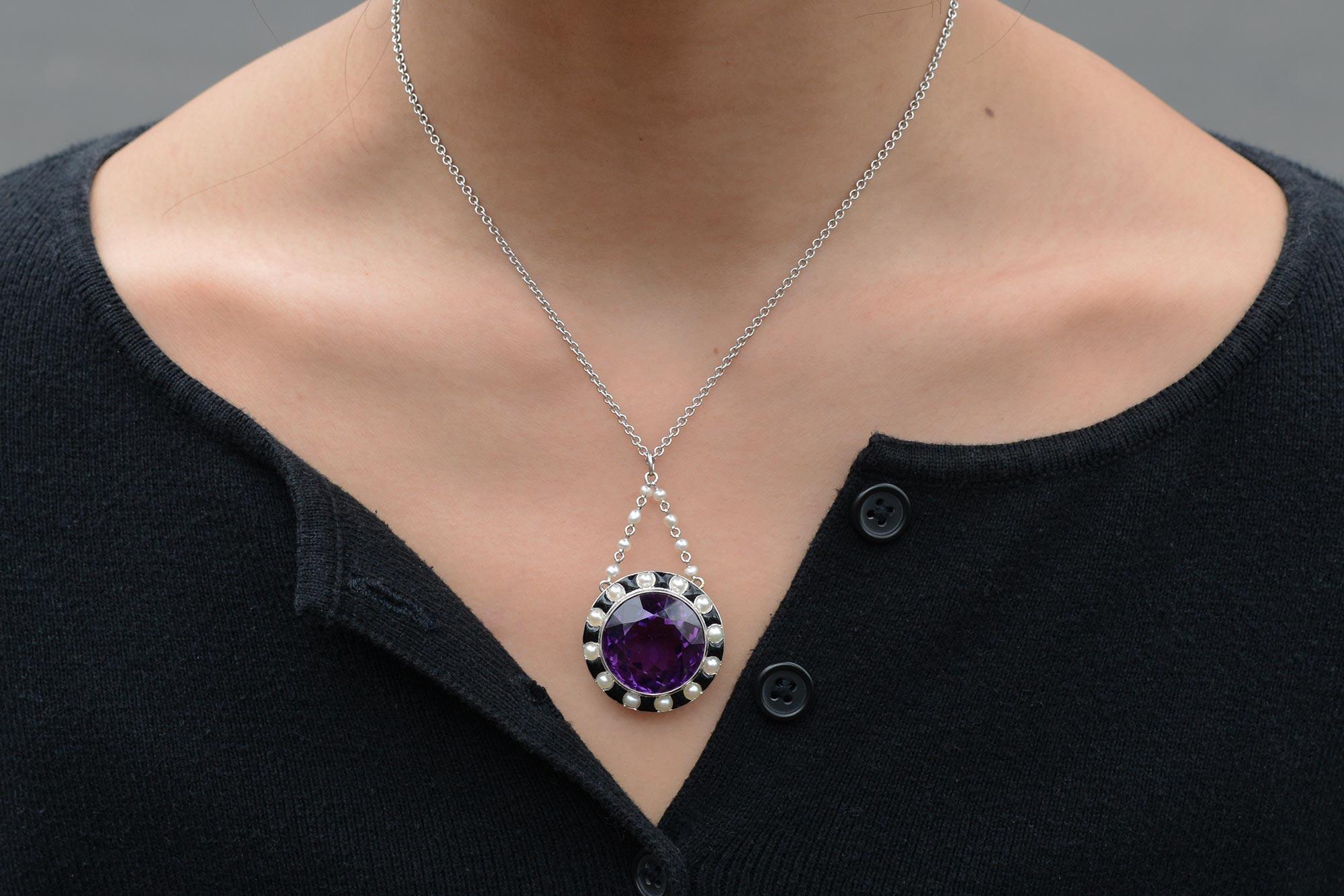 This stunning Art Deco necklace boasts the iconic style of the Jazz Age. Centered by a dazzling, rich violet amethyst of an impressive 30 carats.  The classic 