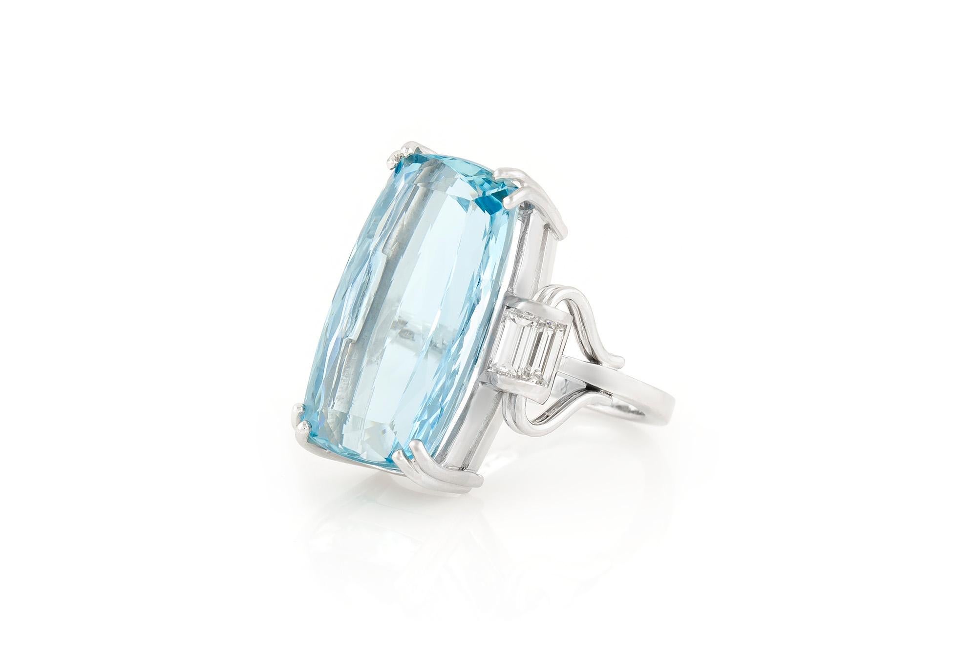 Finely crafted in 18k white gold with a cushion cut Aquamarine weighing approximately 30.00 carats.
The ring features 4 baguette cut side diamonds weighing approximately a total of 1.00 carat.
Art Deco, circa 1930s.
Size 6 1/2, resizable