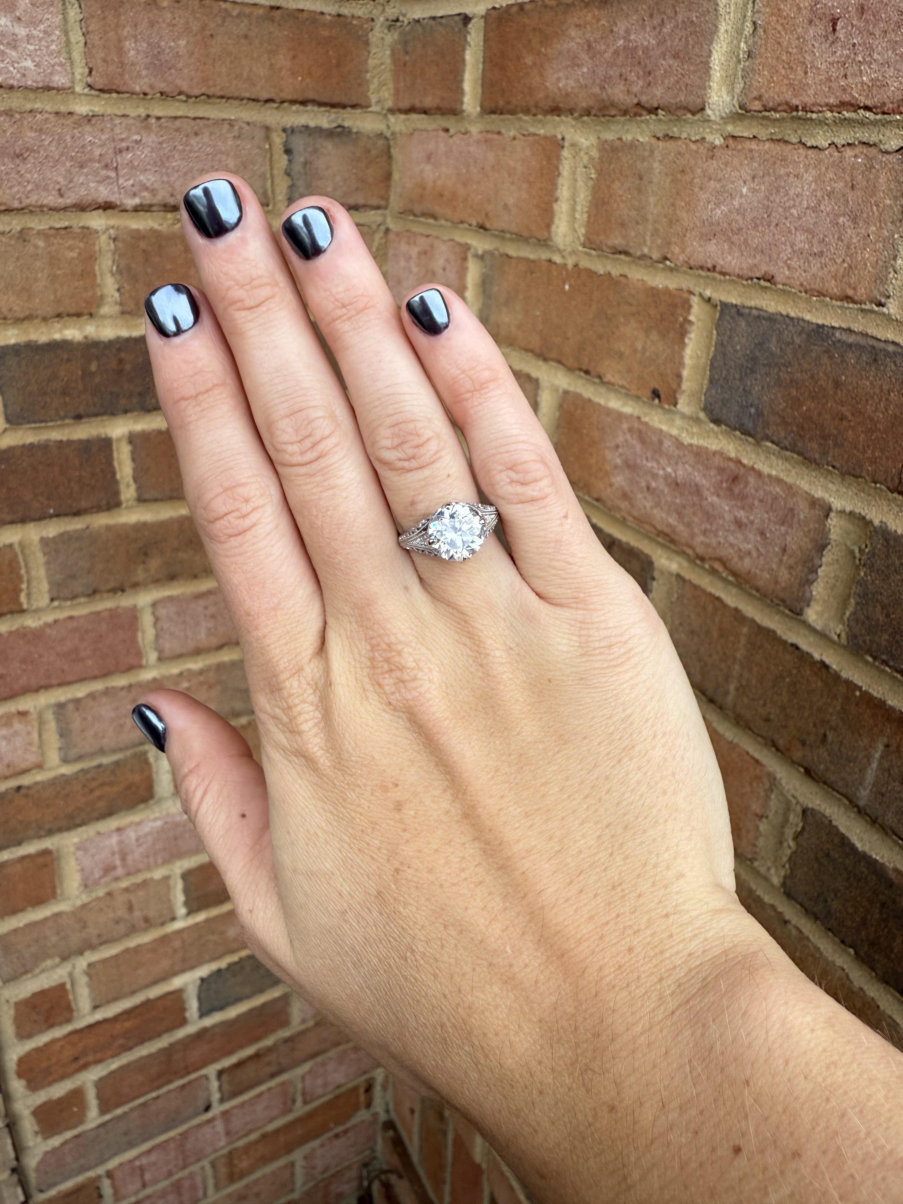 GIA Certified 3 carat old european diamond beautifully set in an antique hand made setting. The setting has 16 1.4mm - 2.0mm single cut diamonds supporting your main stone. The detail and intricacy of the setting along with the brilliance of the