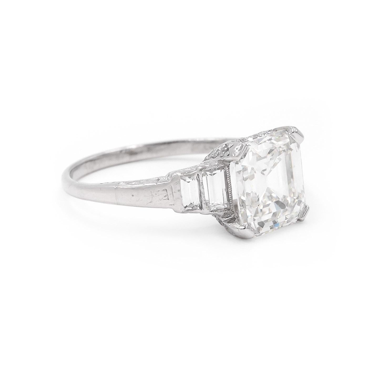 Superb example Art Deco 3.02 Carat Emerald Cut Diamond Engagement Ring composed of platinum. The center diamond is GIA certified H color & VS2 clarity. With an additional 4 Straight Baguette Cut diamonds set into the shoulders weighing approximately