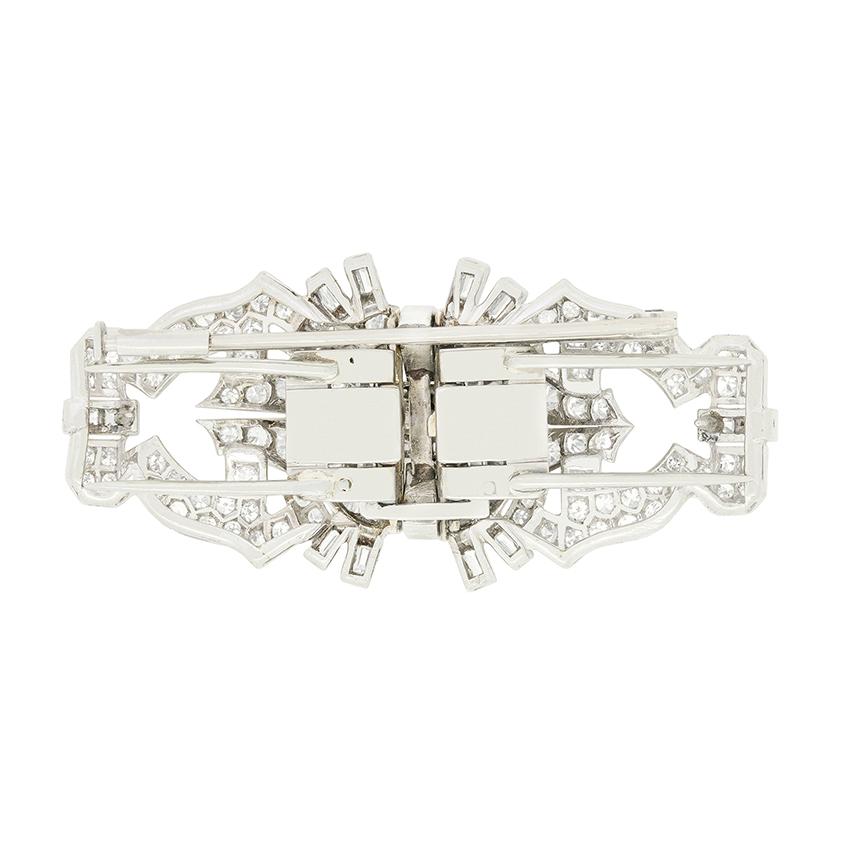 This beautiful brooch is the epitome of Art Deco style. A mix of baguette, old cut and eight cut diamonds encrust the elegantly crafted platinum metalwork to create a wonderful glittering design. The diamonds used total 3.02 carat with colour