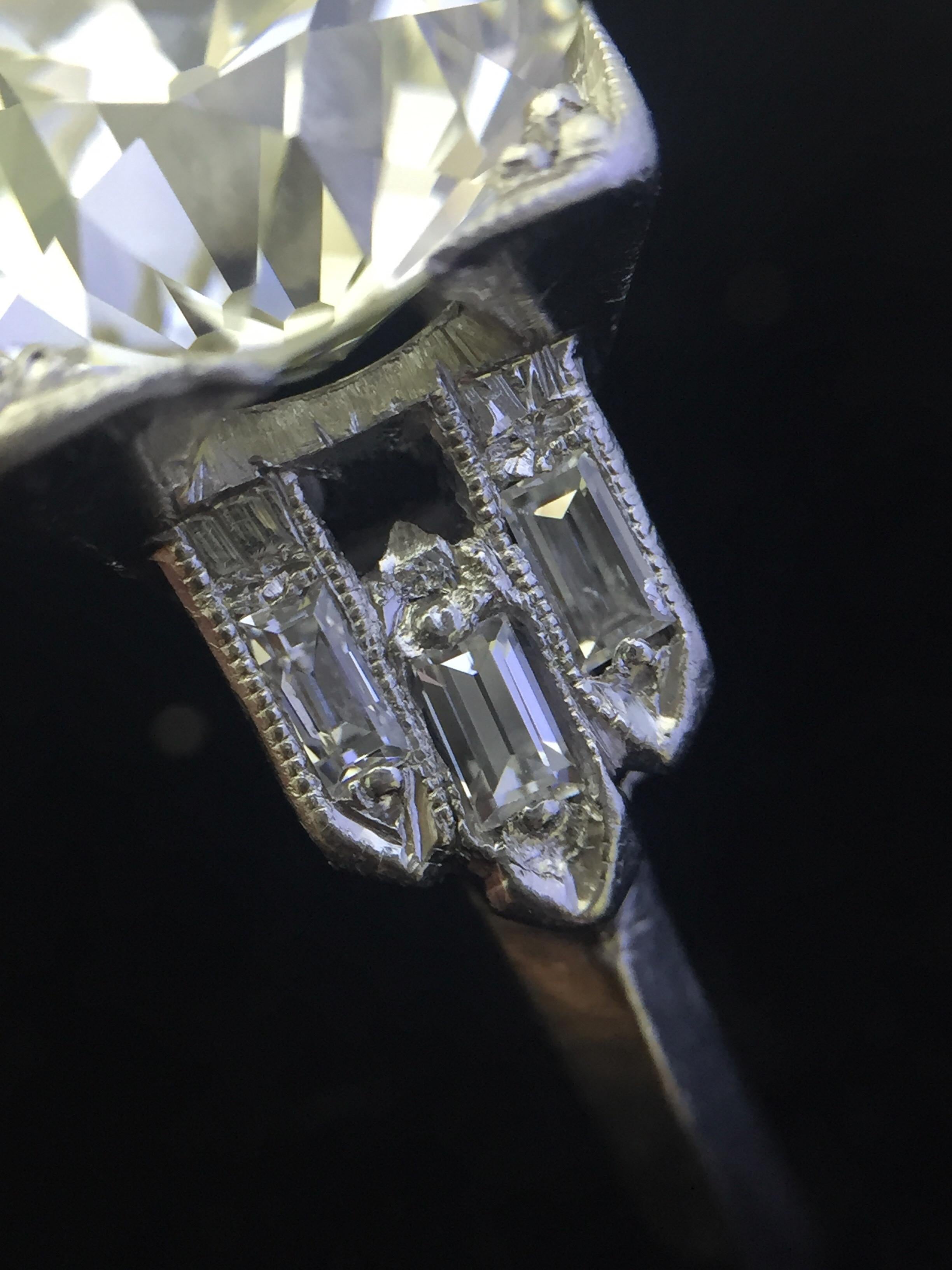 This elegant platinum engagement ring from the Art Deco era is centered with a sparkling old European cut diamond that weighs 3.03ct. graded L-M color with VS2 clarity. The center diamond is accentuated by dazzling baguette cut diamond accents.
The